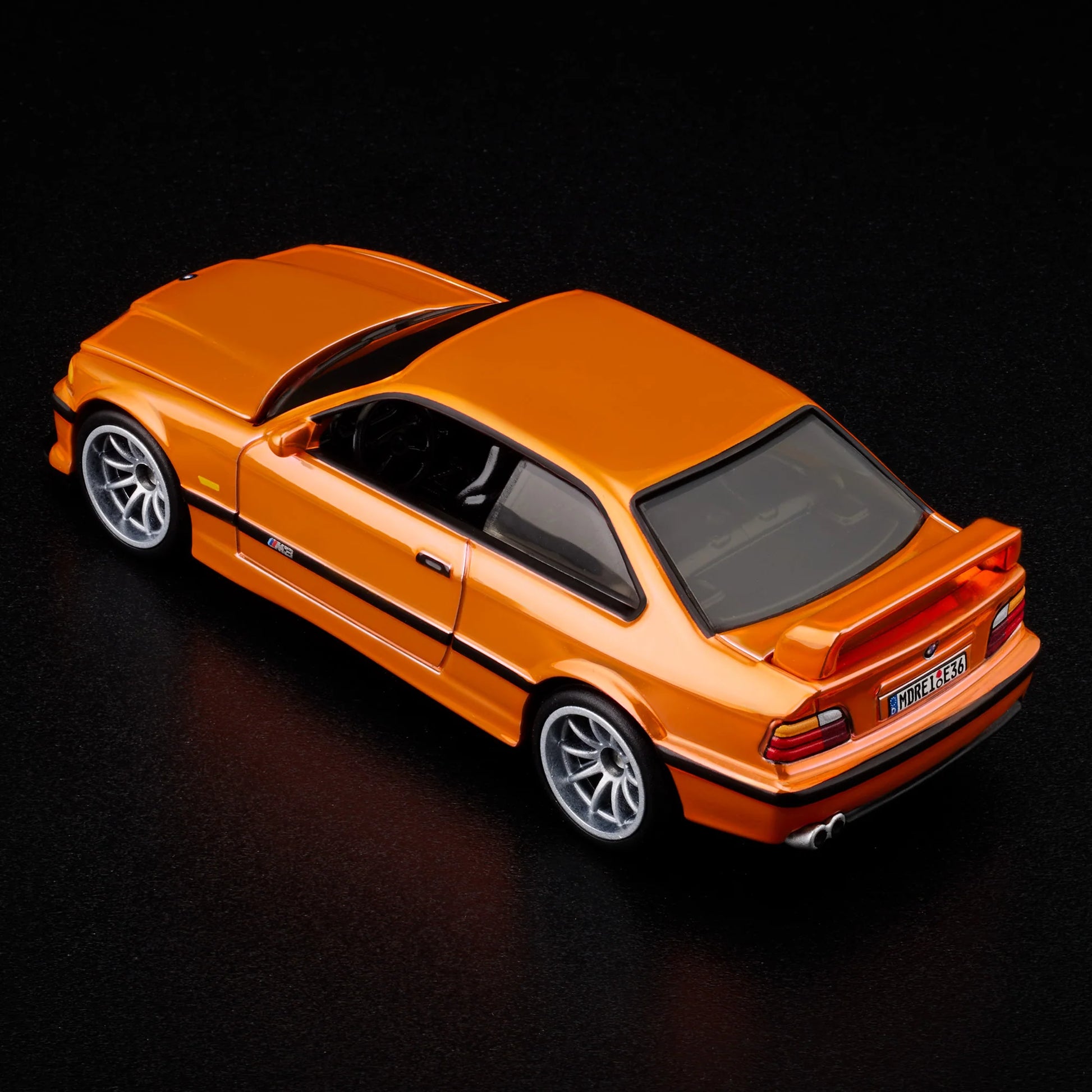 Top-down view of bright orange BMW M3 LTW 1995 Hot Wheels model