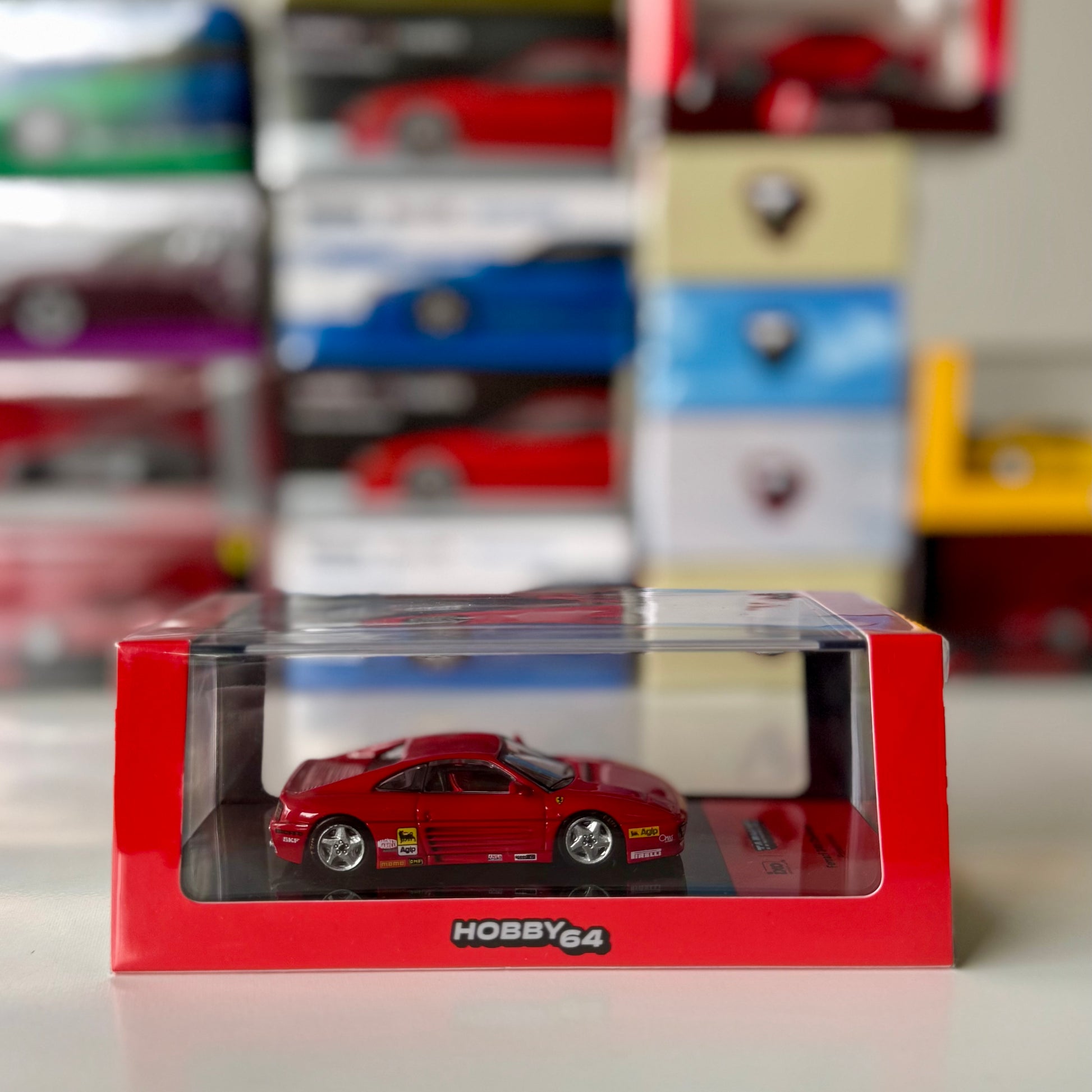 Front view of boxed Ferrari 348 Challenge Presentation 1:64 by Tarmac Works