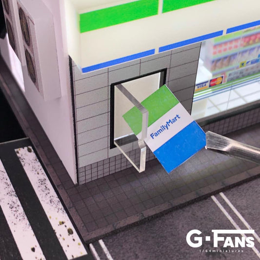 Close-up of Family Mart logo and signs on miniature diorama