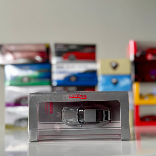 Angled packaging shot of 1:64 Porsche 993 Remastered by Gunther Werks in grey