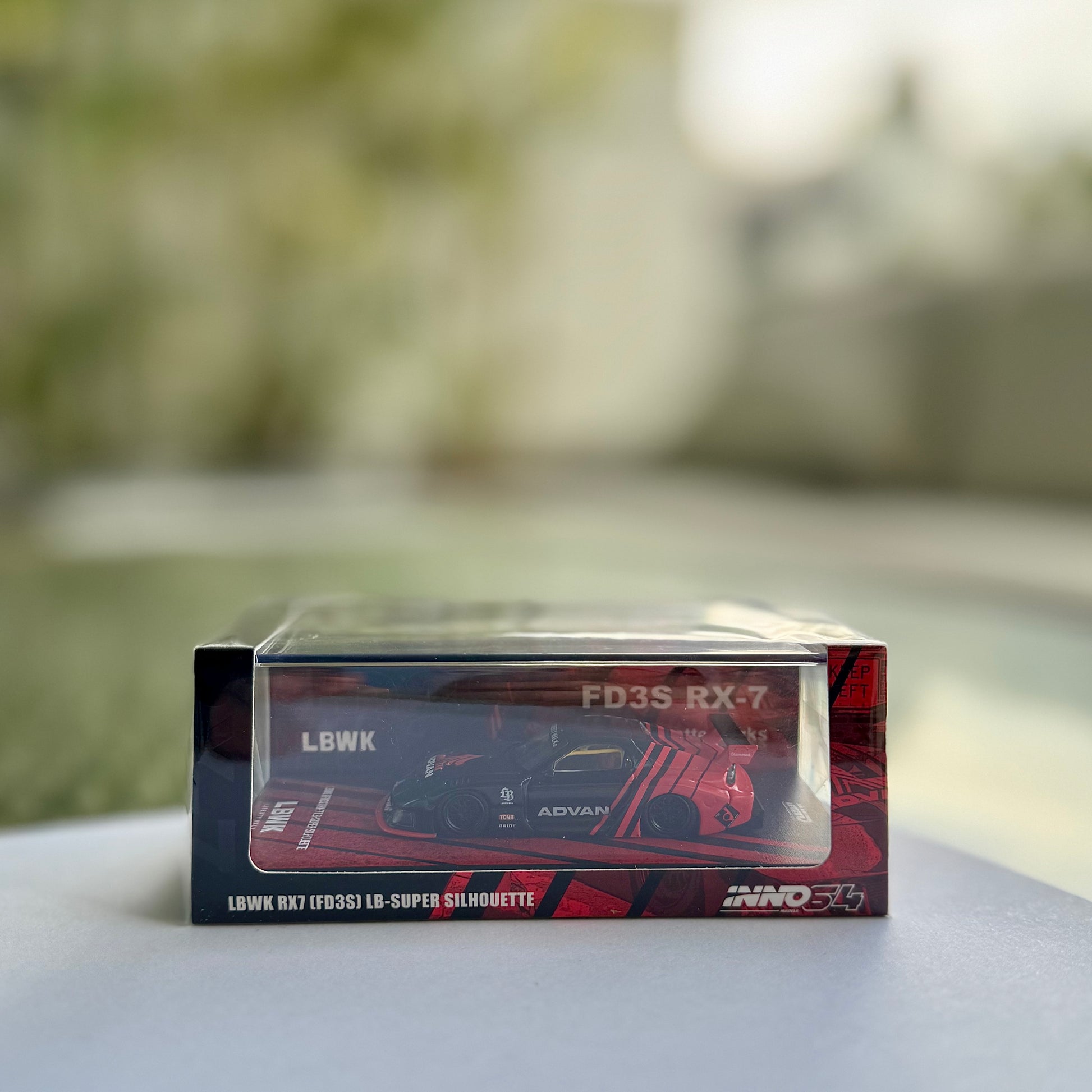 Front view of INNO64 Mazda RX-7 FD3S LBWK Super Silhouette in Advan livery