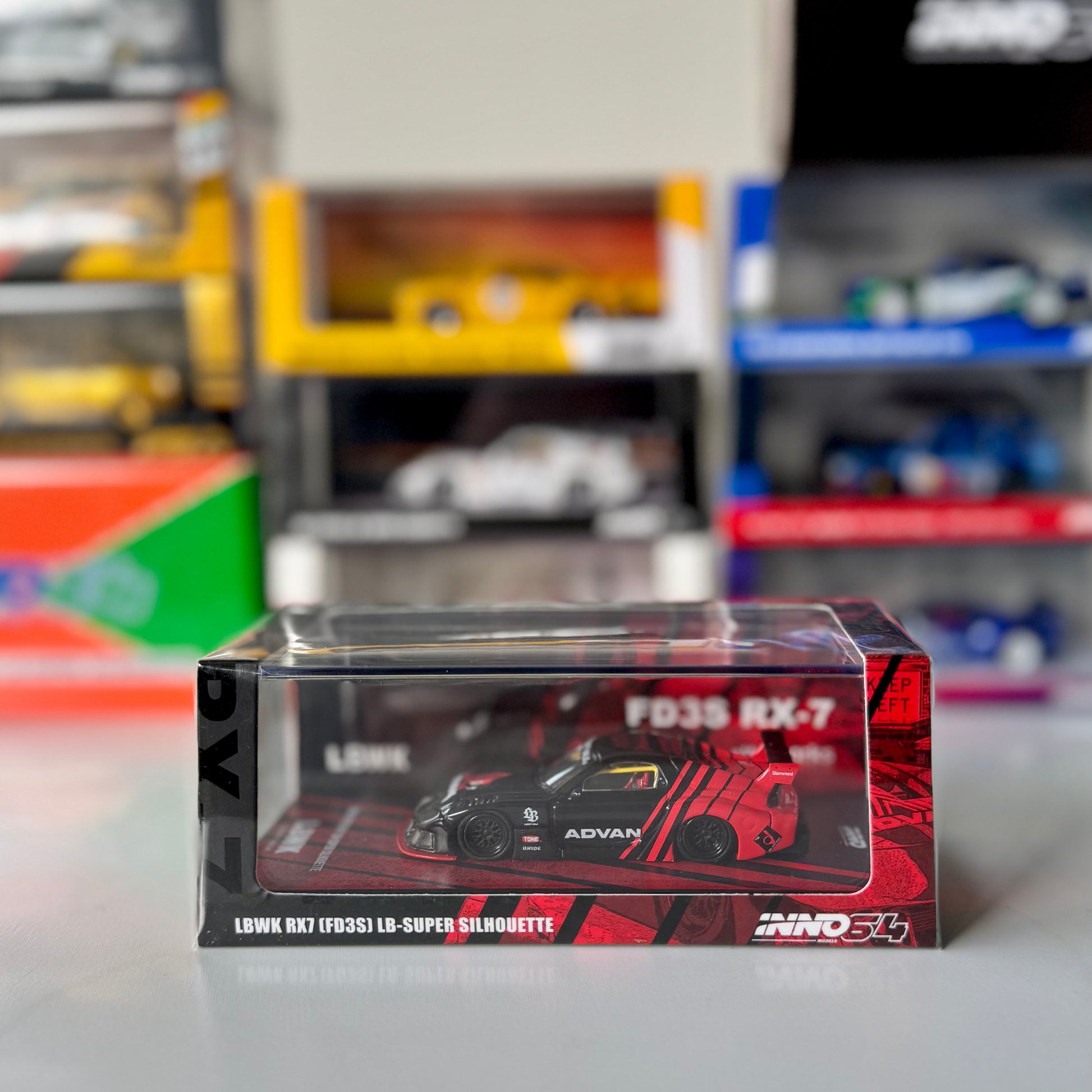 Front view of INNO64 Mazda RX-7 FD3S LBWK Super Silhouette in Advan livery