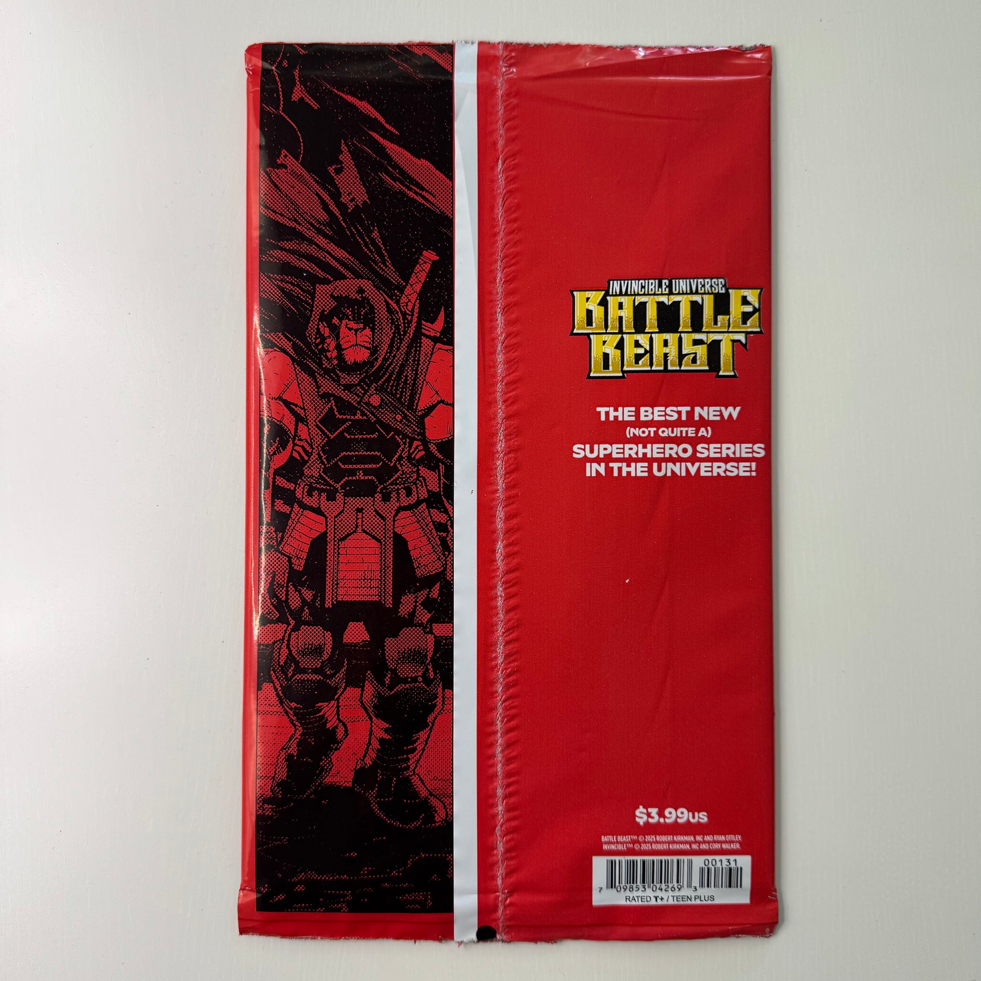 Comic book packaging showing Invincible Universe branding and sealed bag from the back