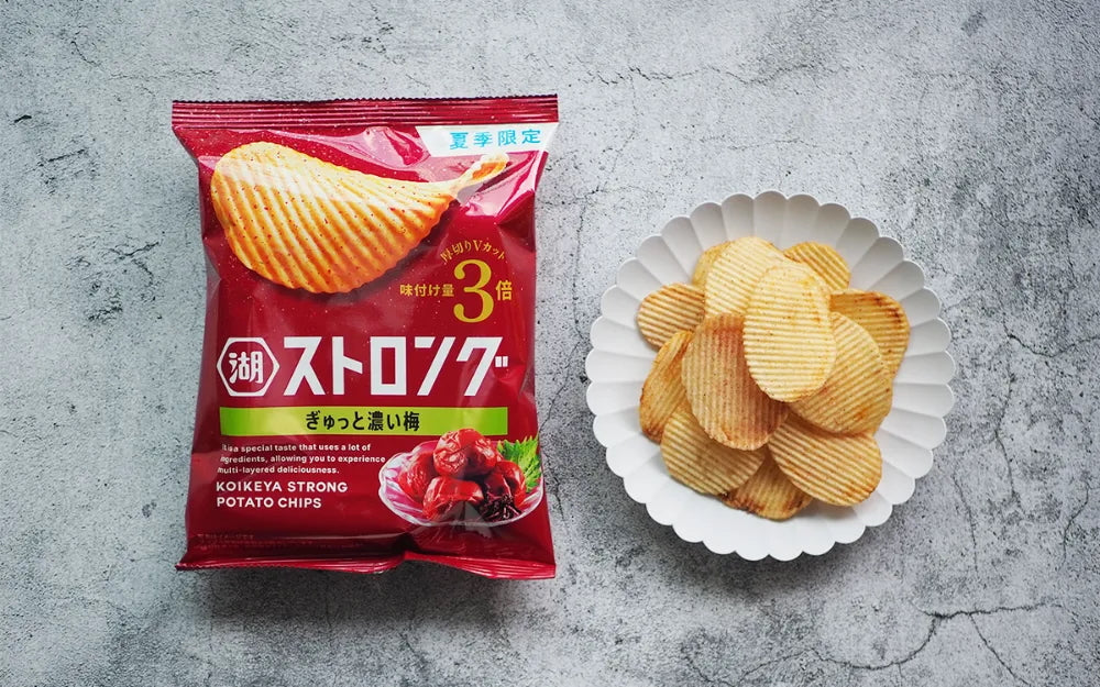 Koikeya Strong Ume Plum Chips 52g unpacked next to a plate full of thick-cut Japanese potato chips