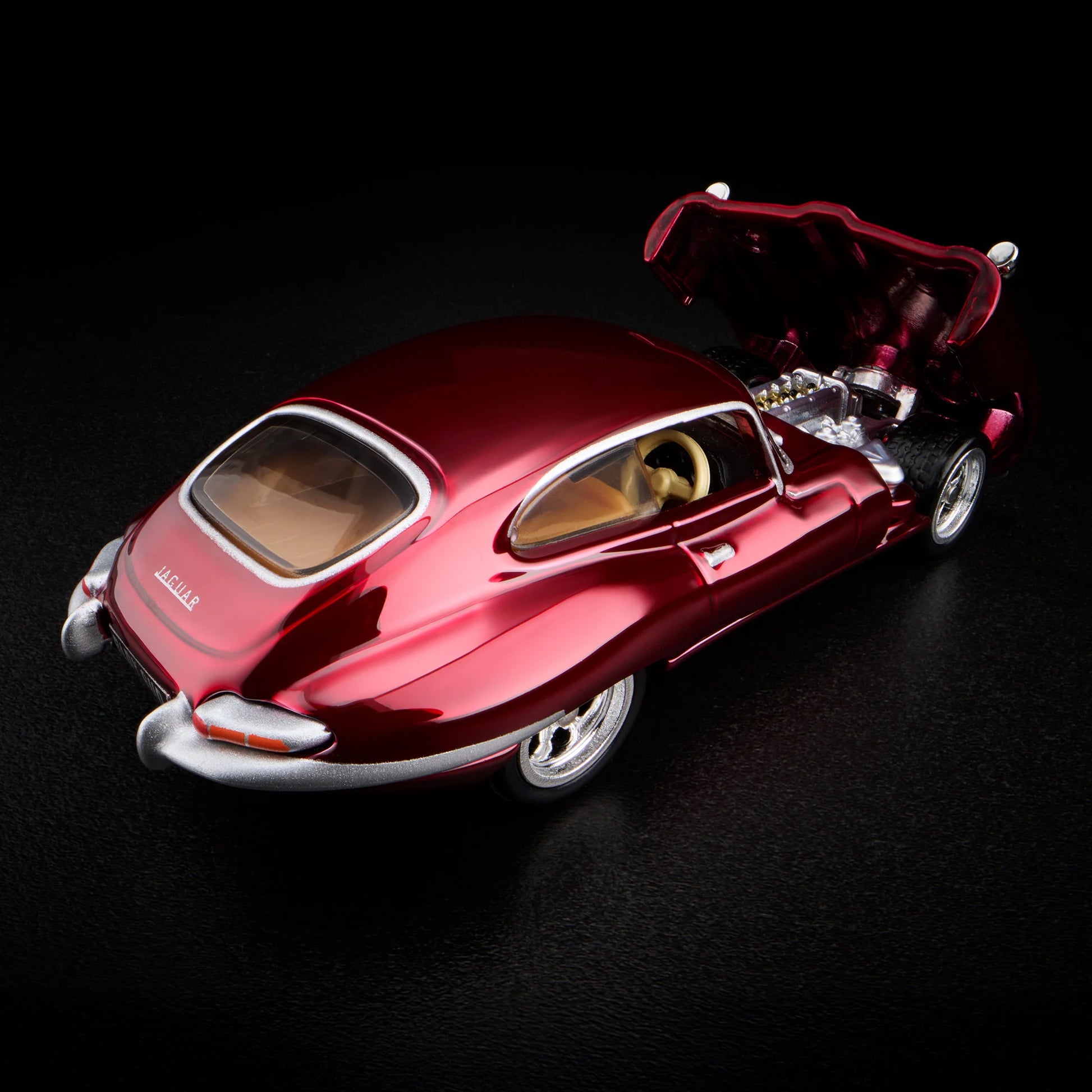 Top-down view of unboxed 1964 Jaguar E-Type in Spectraflame oxblood paint
