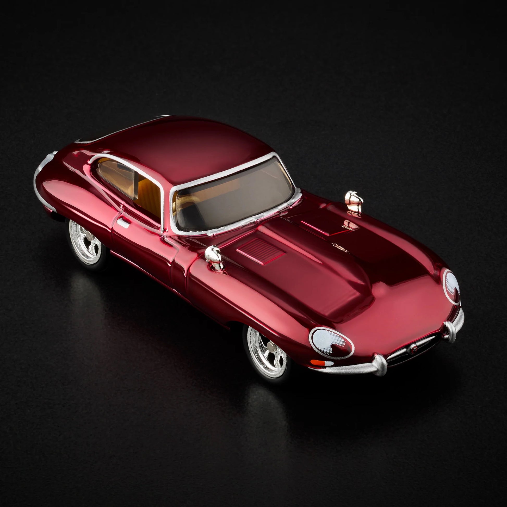 Top-down view of unboxed 1964 Jaguar E-Type in Spectraflame oxblood paint