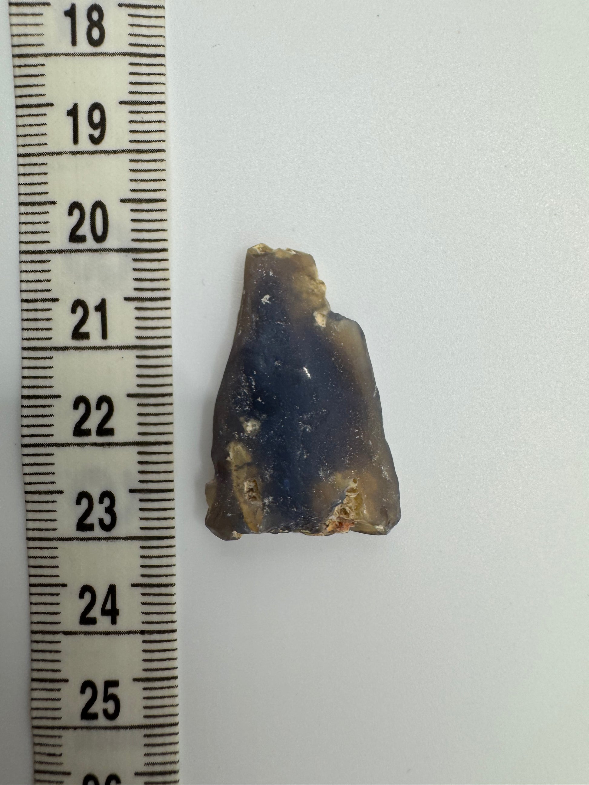 Close-up of natural Australian opal embedded in host rock, highlighting vibrant colors and texture other side.