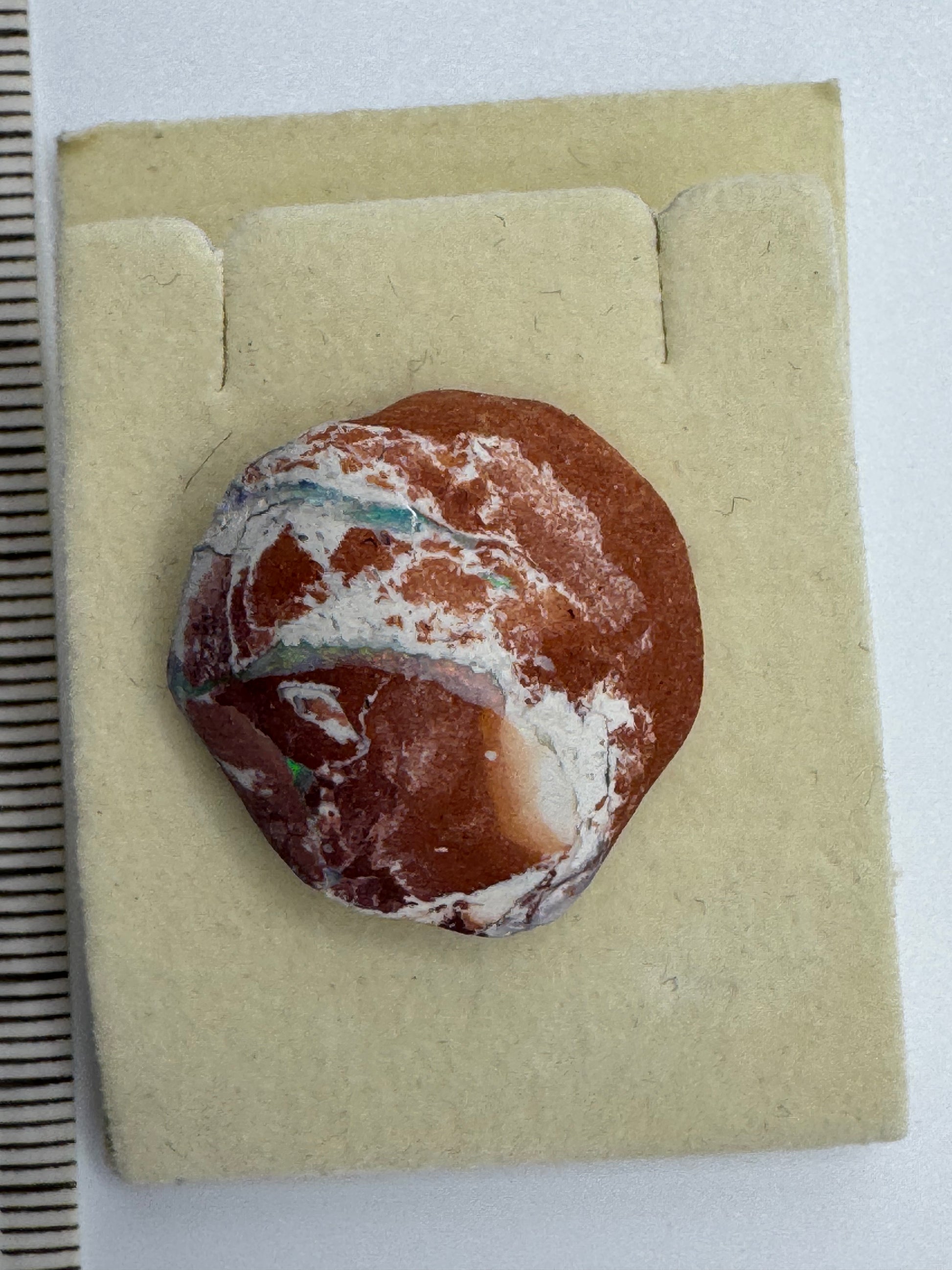 Close-up of natural Australian opal embedded in host rock, highlighting vibrant colors and texture.