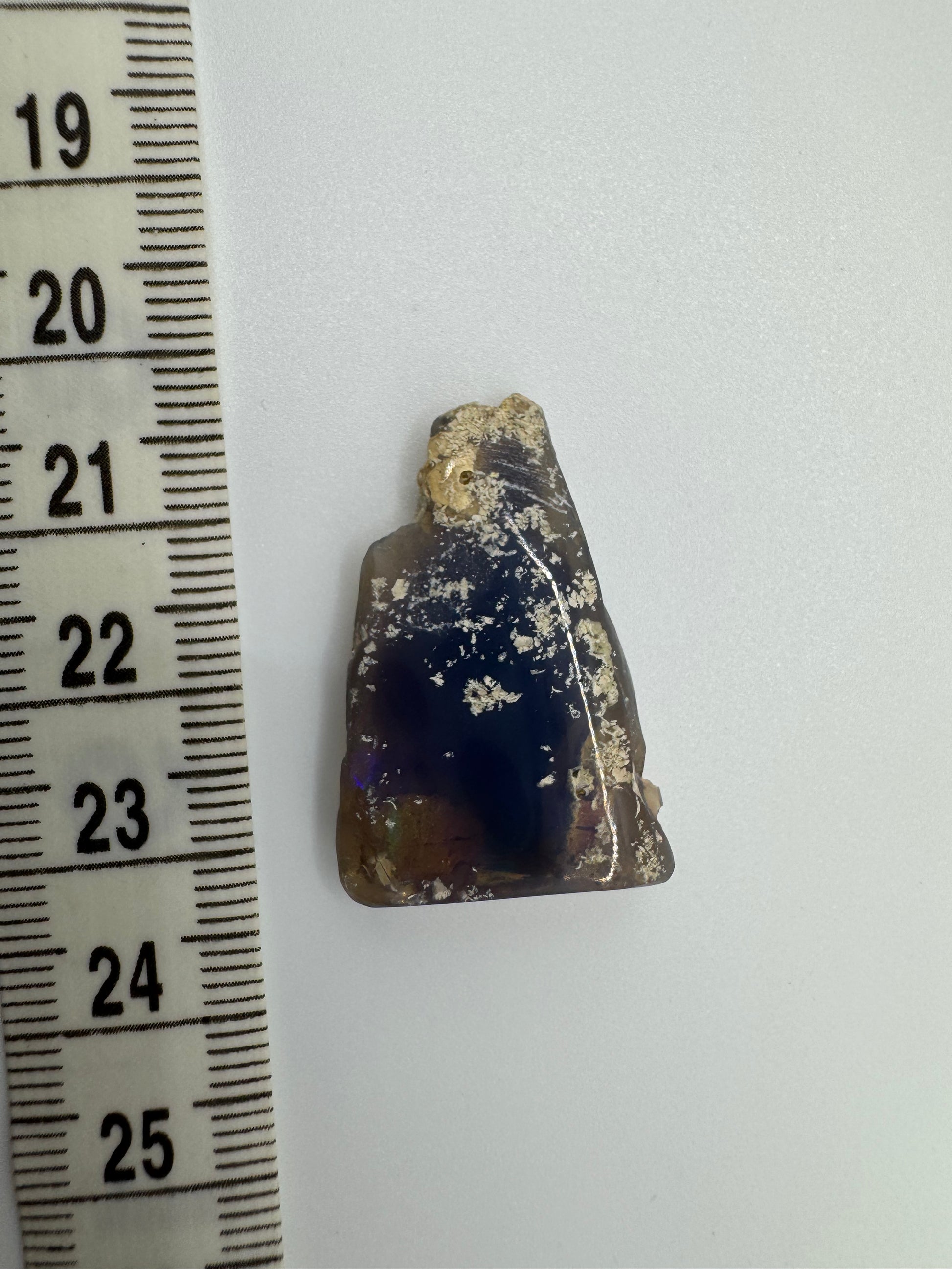 Close-up of natural Australian opal embedded in host rock, highlighting vibrant colors and texture.