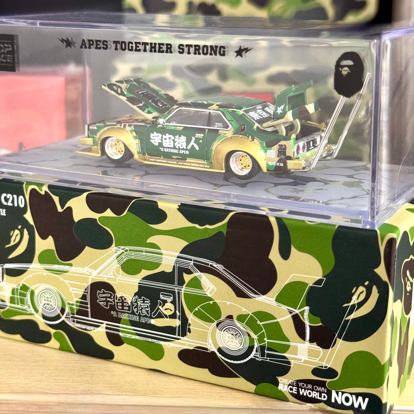 Left side angle of diecast Kaido Racer Skyline BAPE inside acrylic case