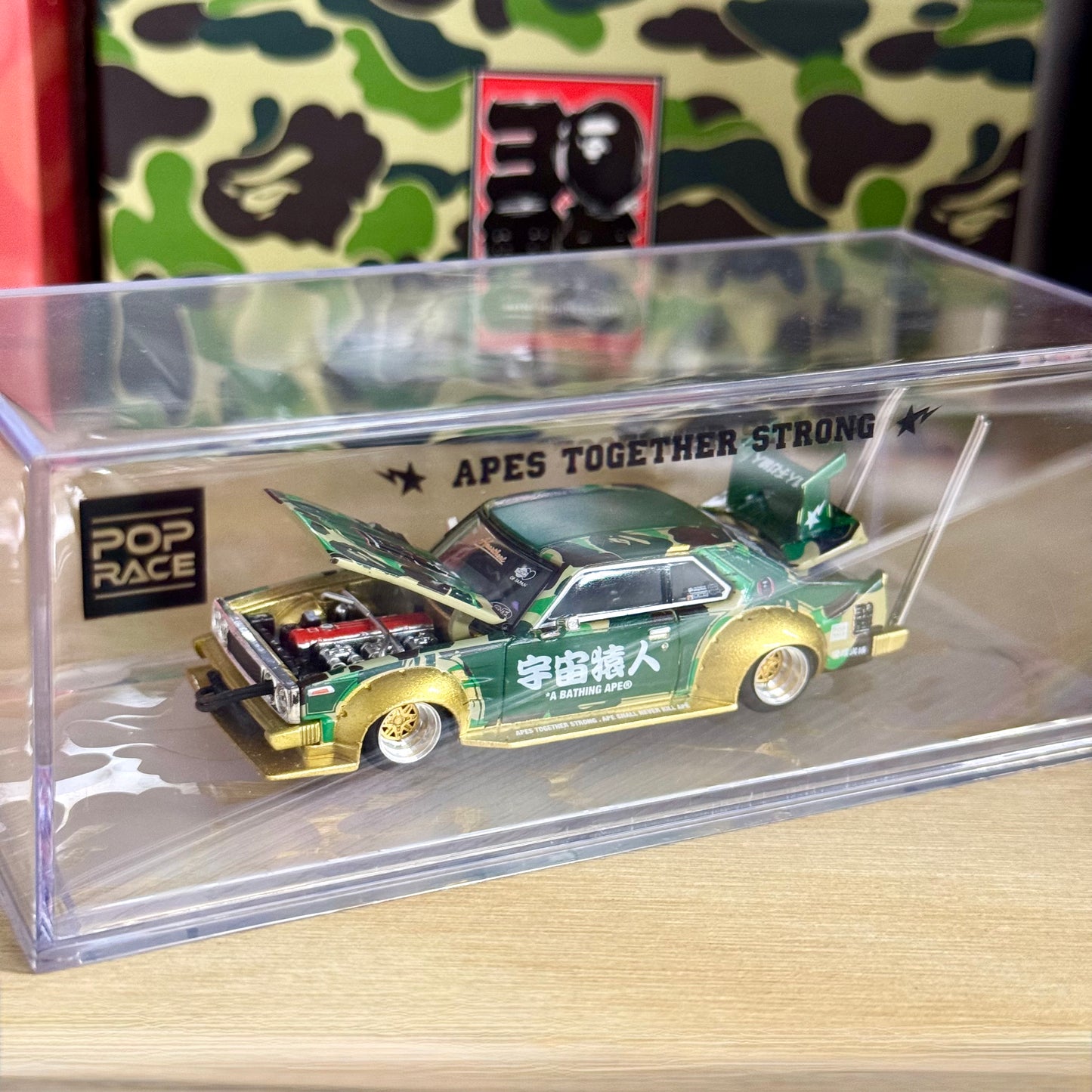 Top-down view of BAPE edition Nissan Skyline C210 Kaido Racer in packaging case