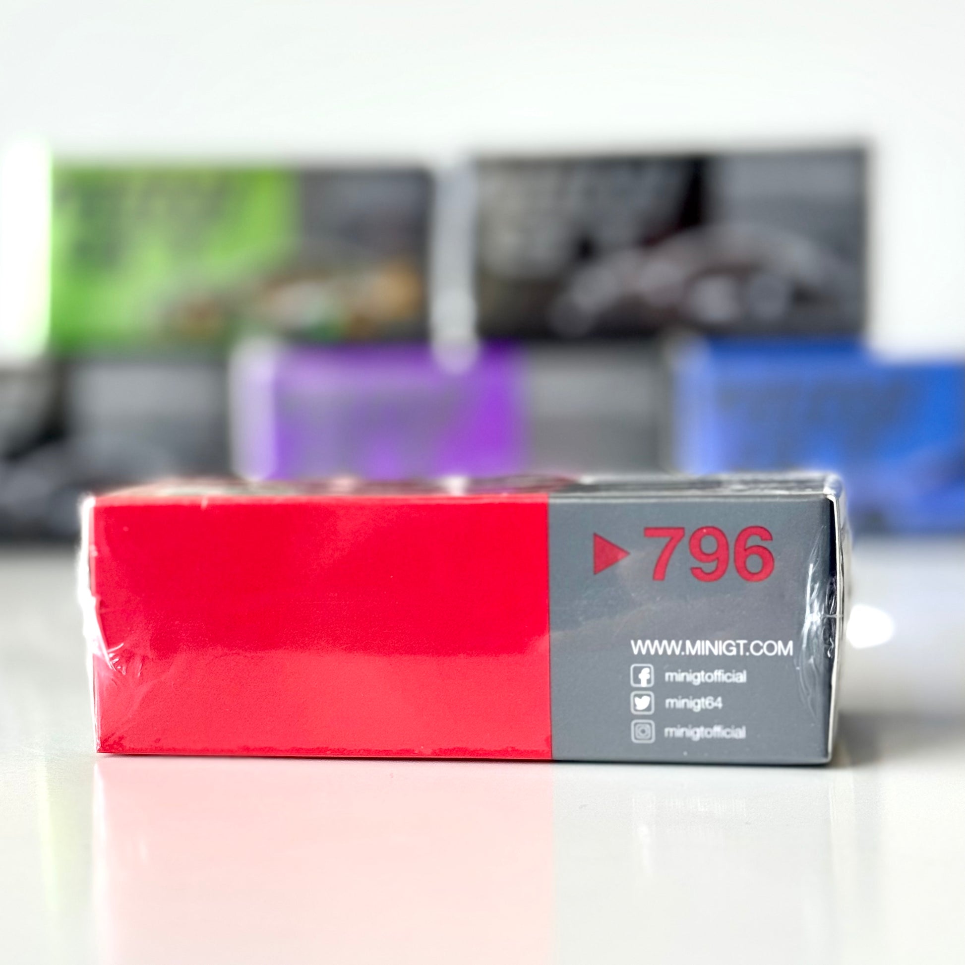 Side view of Mini GT packaging for R34 GT-R V-Spec in Active Red