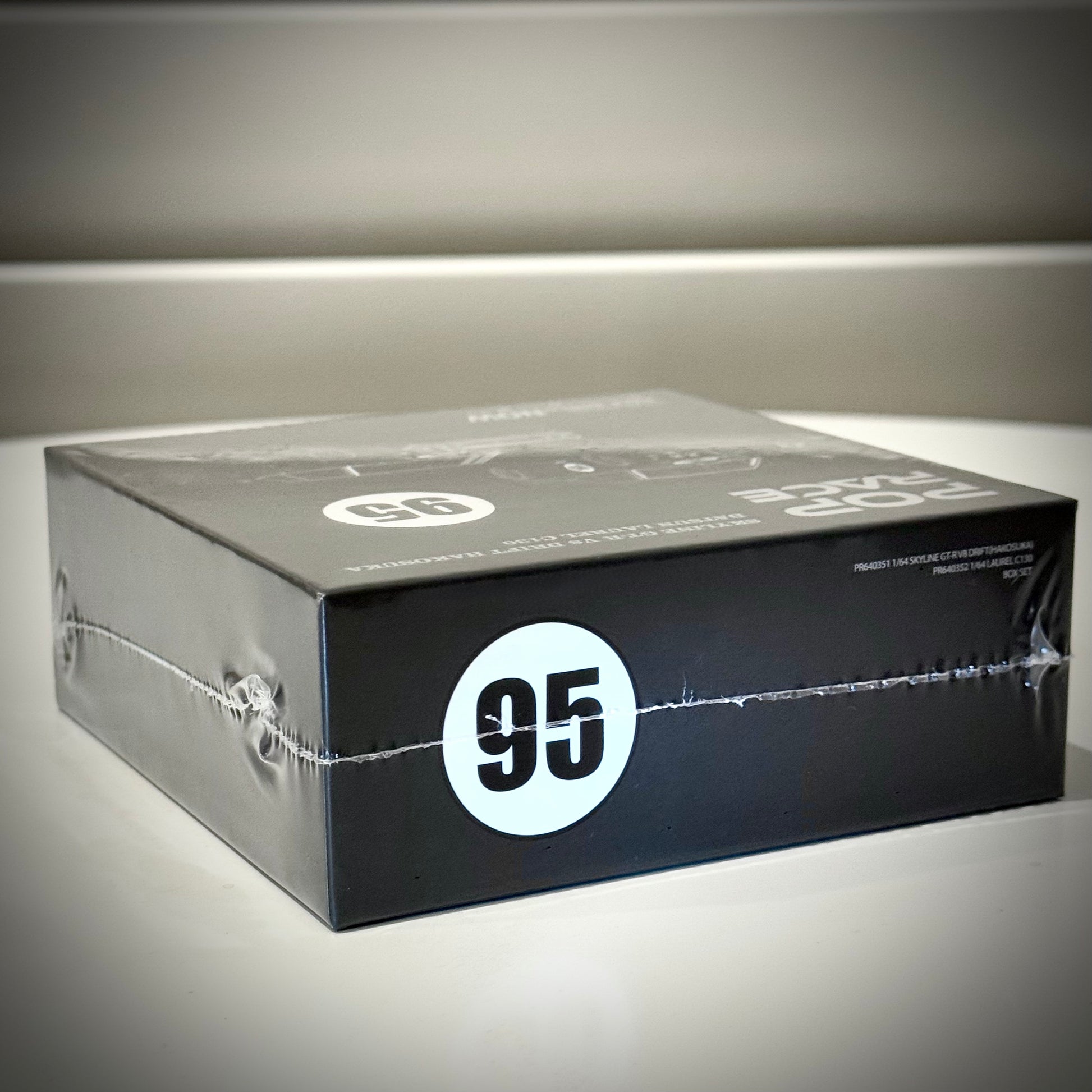 Side view of Pop Race Skyline GT-R Hakosuka and Datsun Laurel C130 1:64 event exclusive box – Toycar Salon 2025.