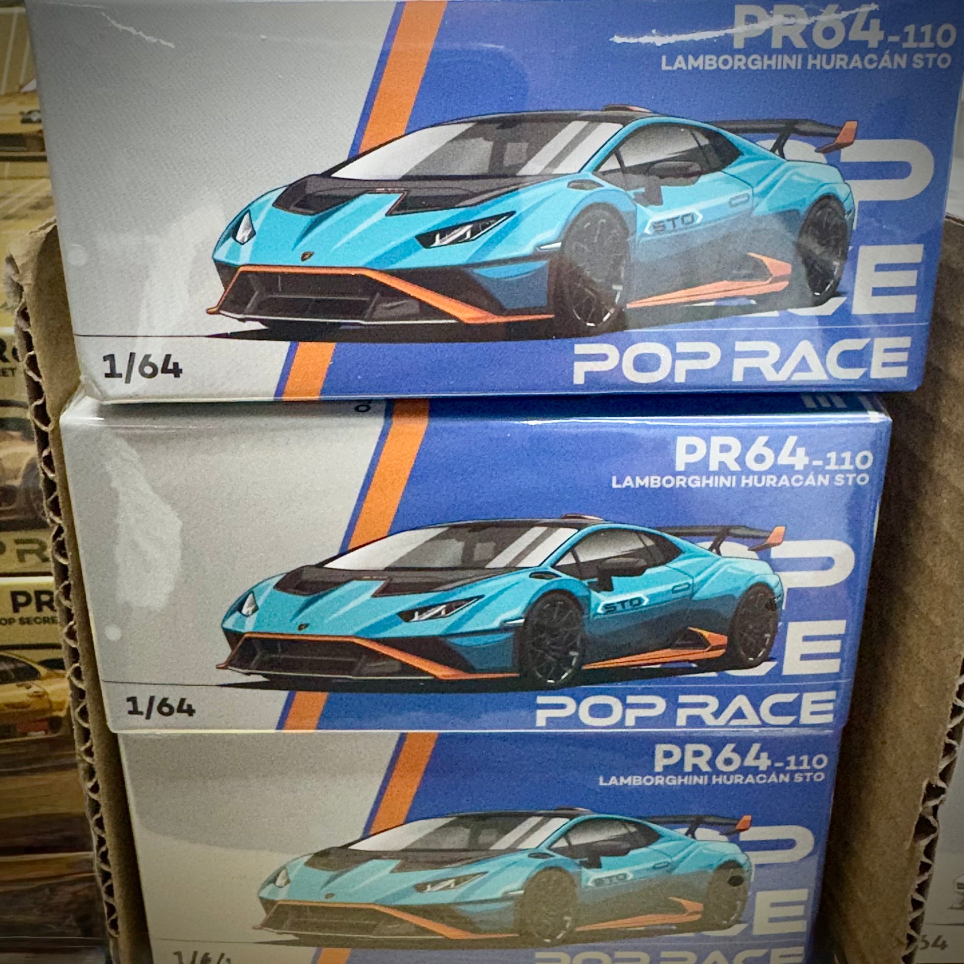 Front view of Pop Race Lamborghini Huracan STO 1:64 diecast model in standard box stacks
