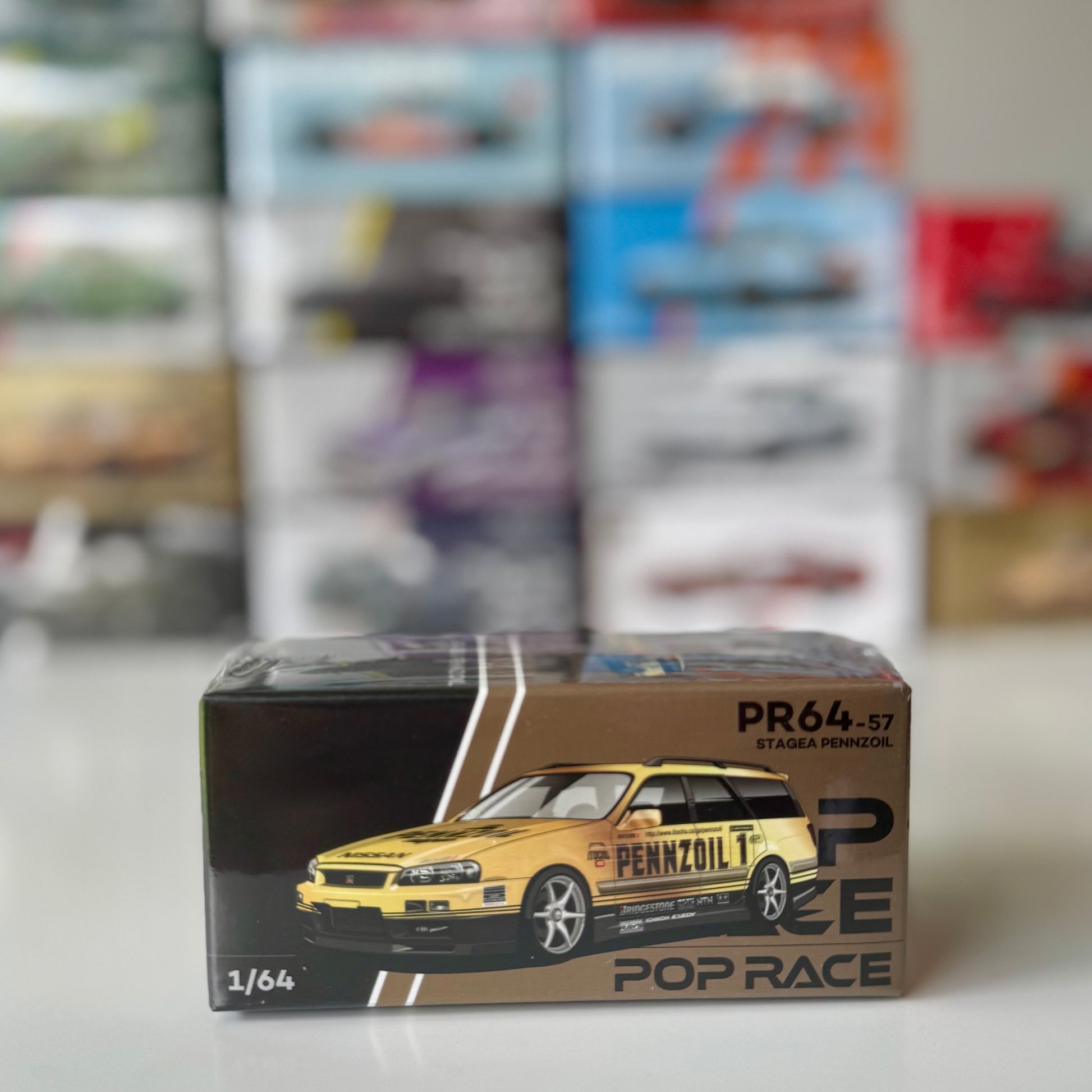 Front angle of Pop Race Nissan Stagea R34 Pennzoil Gold Chrome 1:64 diecast car