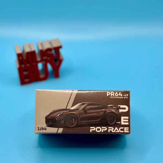 Front view of Pop Race Porsche 992 Stinger GTR Carbon Brown model in box