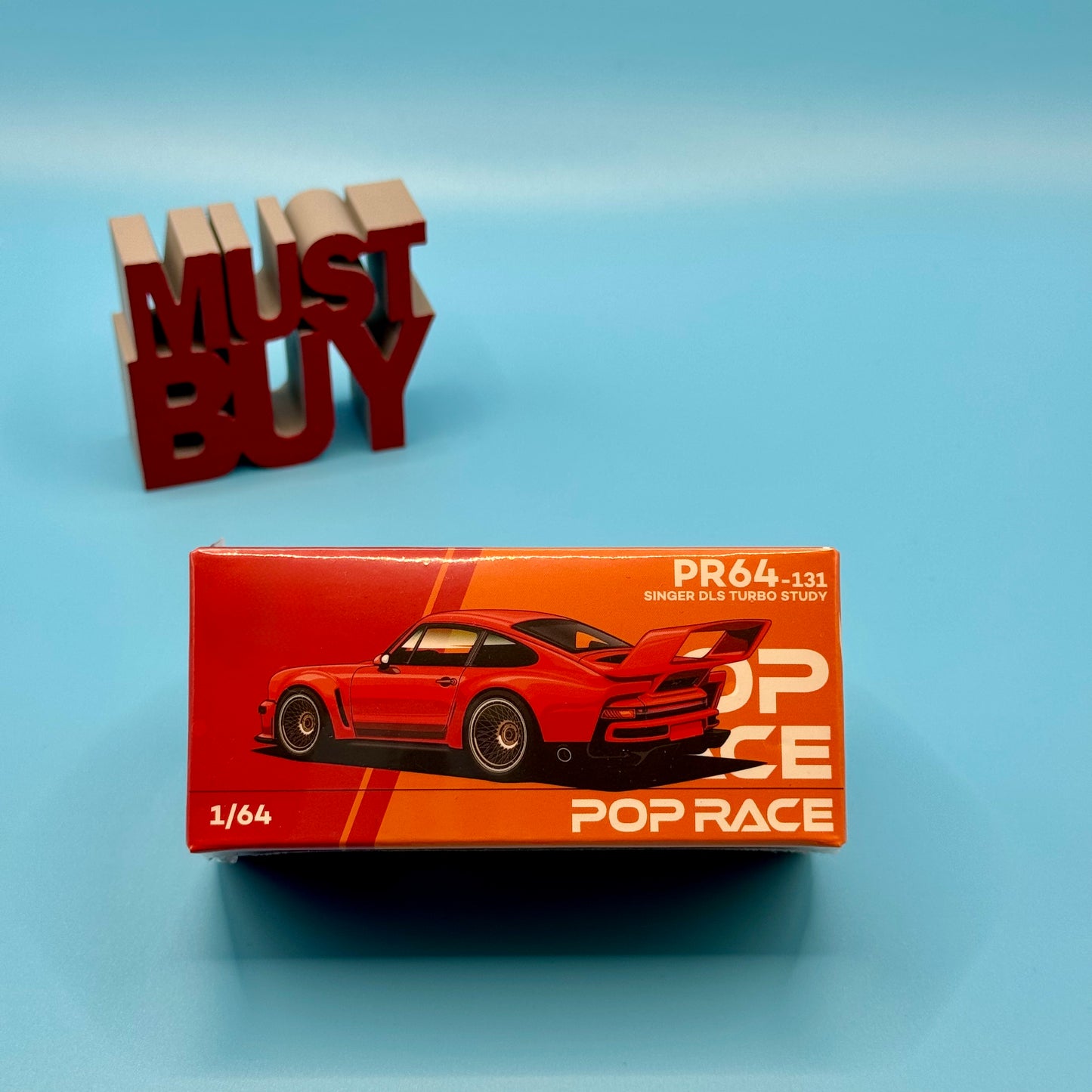 Front view of boxed Pop Race Singer DLS Turbo Study 1:64 diecast model