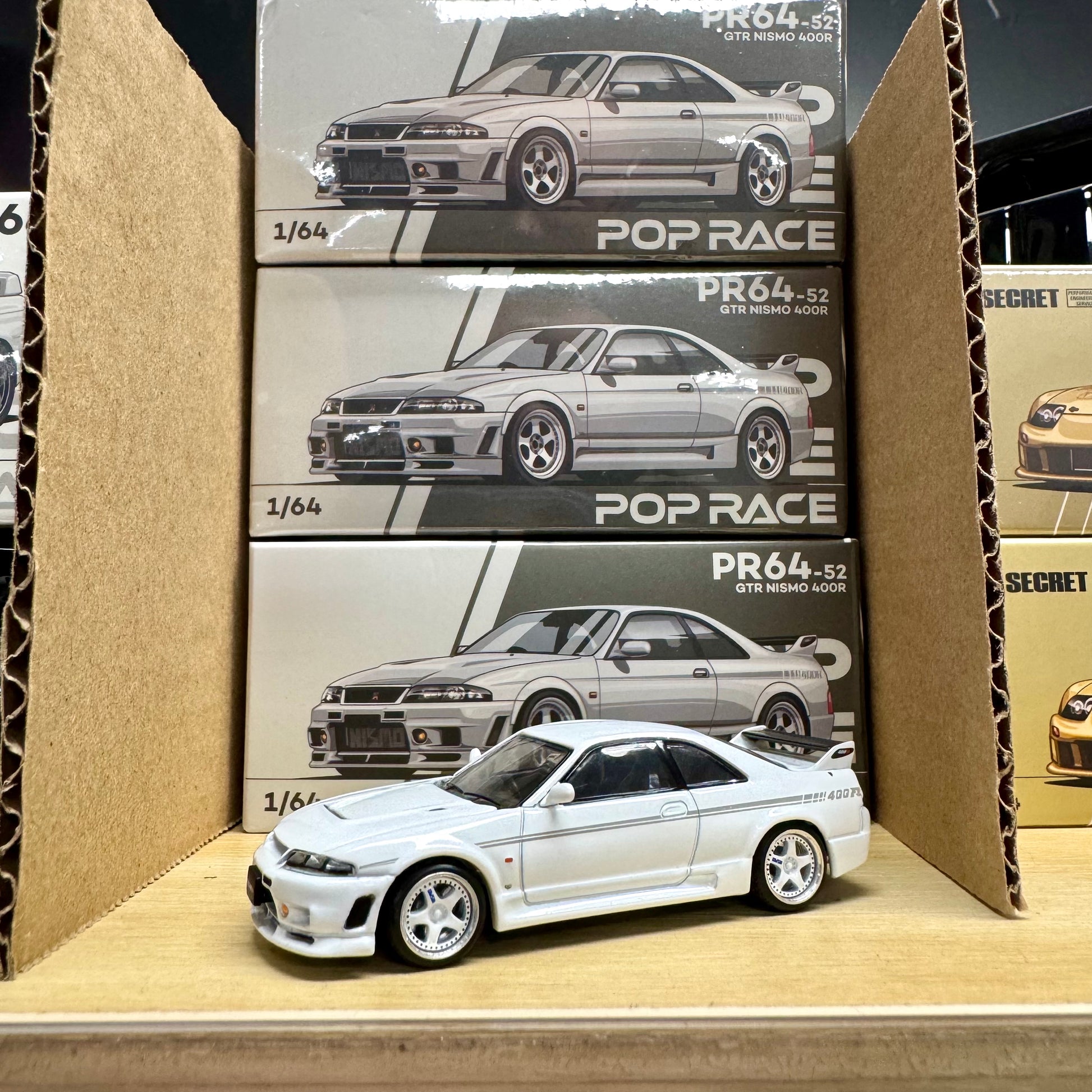 Front view of Nissan GT-R R33 Nismo 400R White 1:64 model car out of box