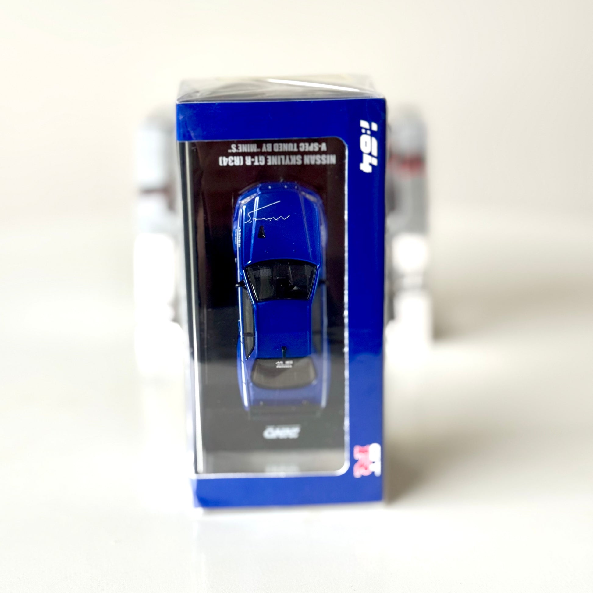 Top-down view of INNO64 R34 GT-R Mine’s Blue 1:64 model in box