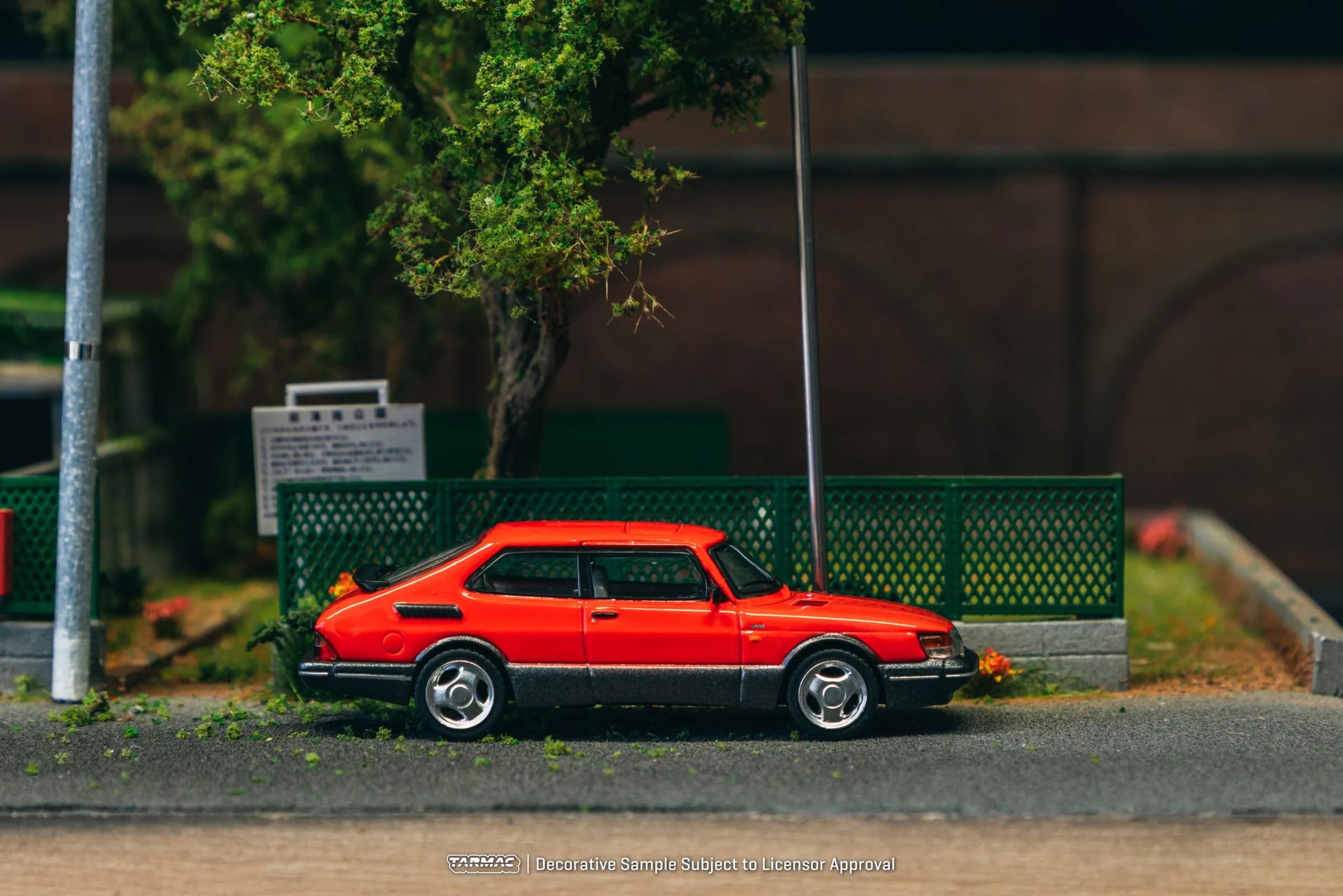 Saab 900 Turbo Red diecast model displayed in diorama scene – side view