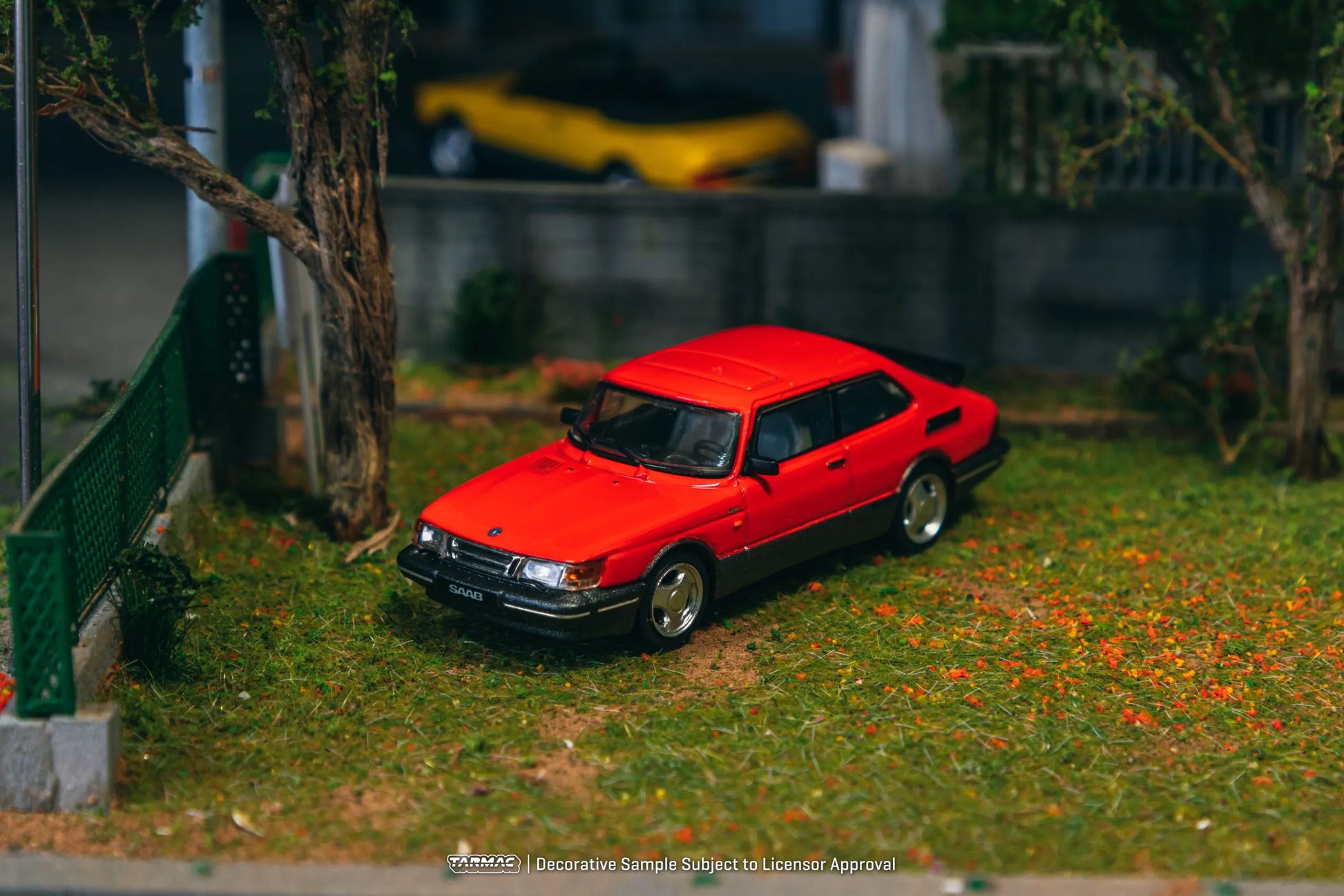 Saab 900 Turbo Red diecast model displayed in diorama scene – side view