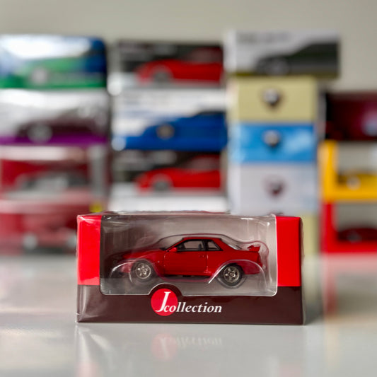 Front view of boxed Nissan Skyline GT-R BNR32 Red 1:64 by Tarmac Works