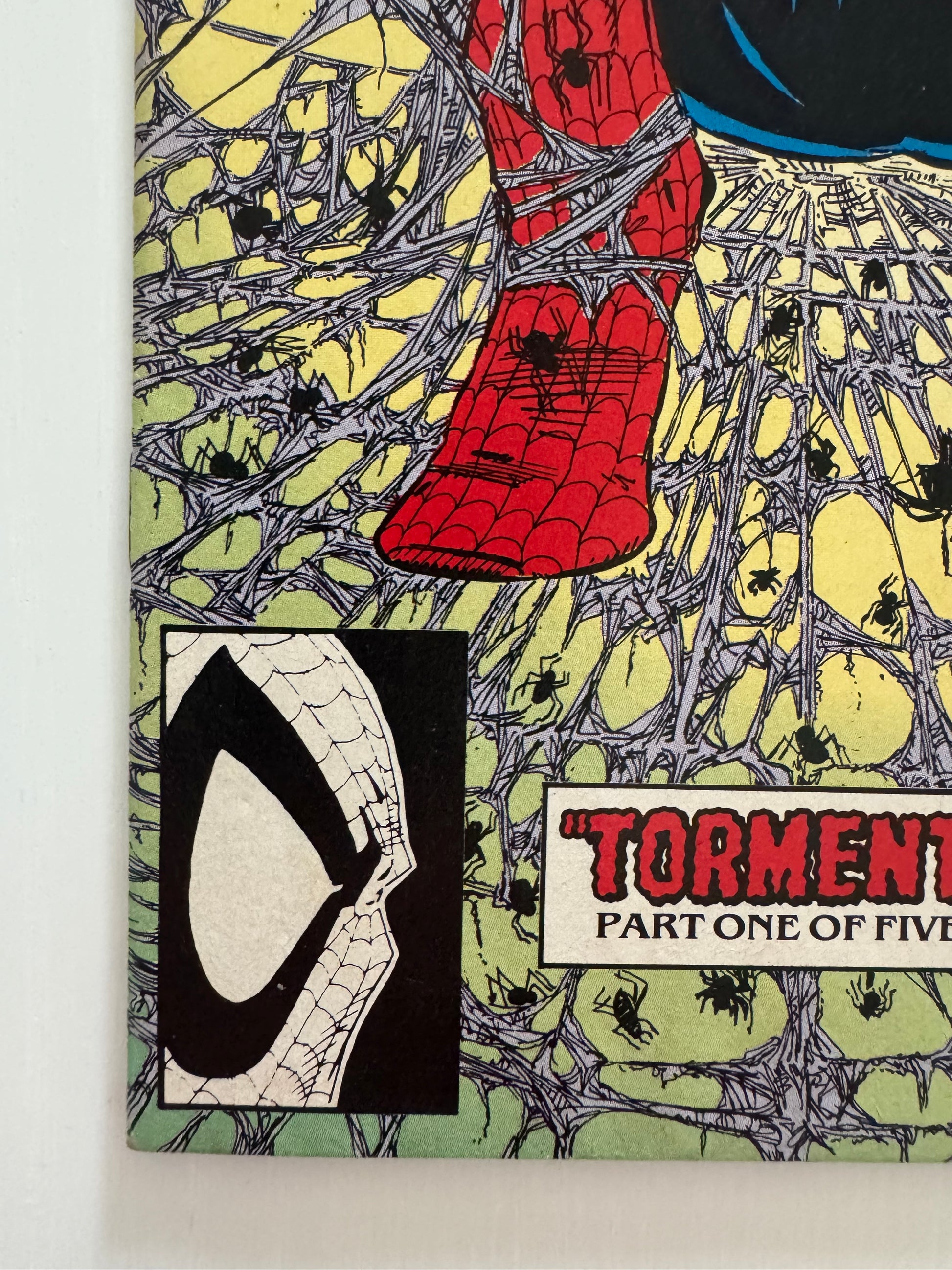 Detailed view of Todd McFarlane’s Spider-Man illustration from the front cover of Spider-Man #1 (1990), showing web textures and character design.