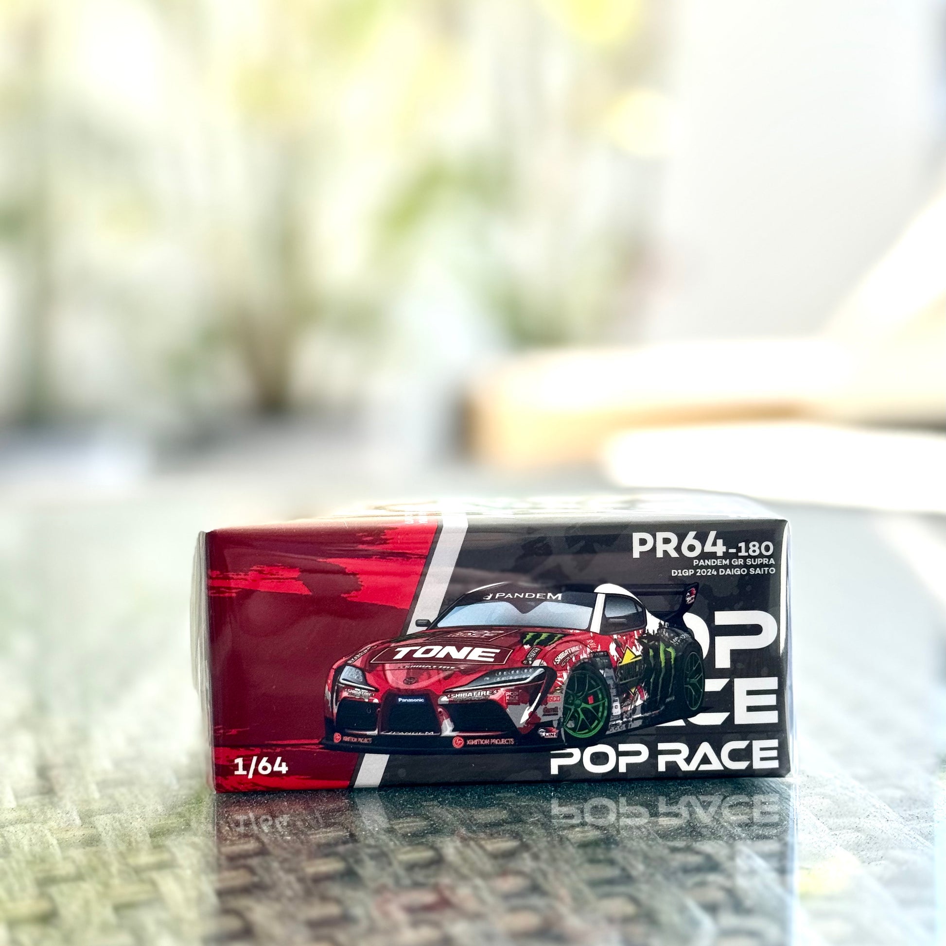 Front view of boxed Toyota GR Supra D1GP 2024 1:64 model by Pop Race