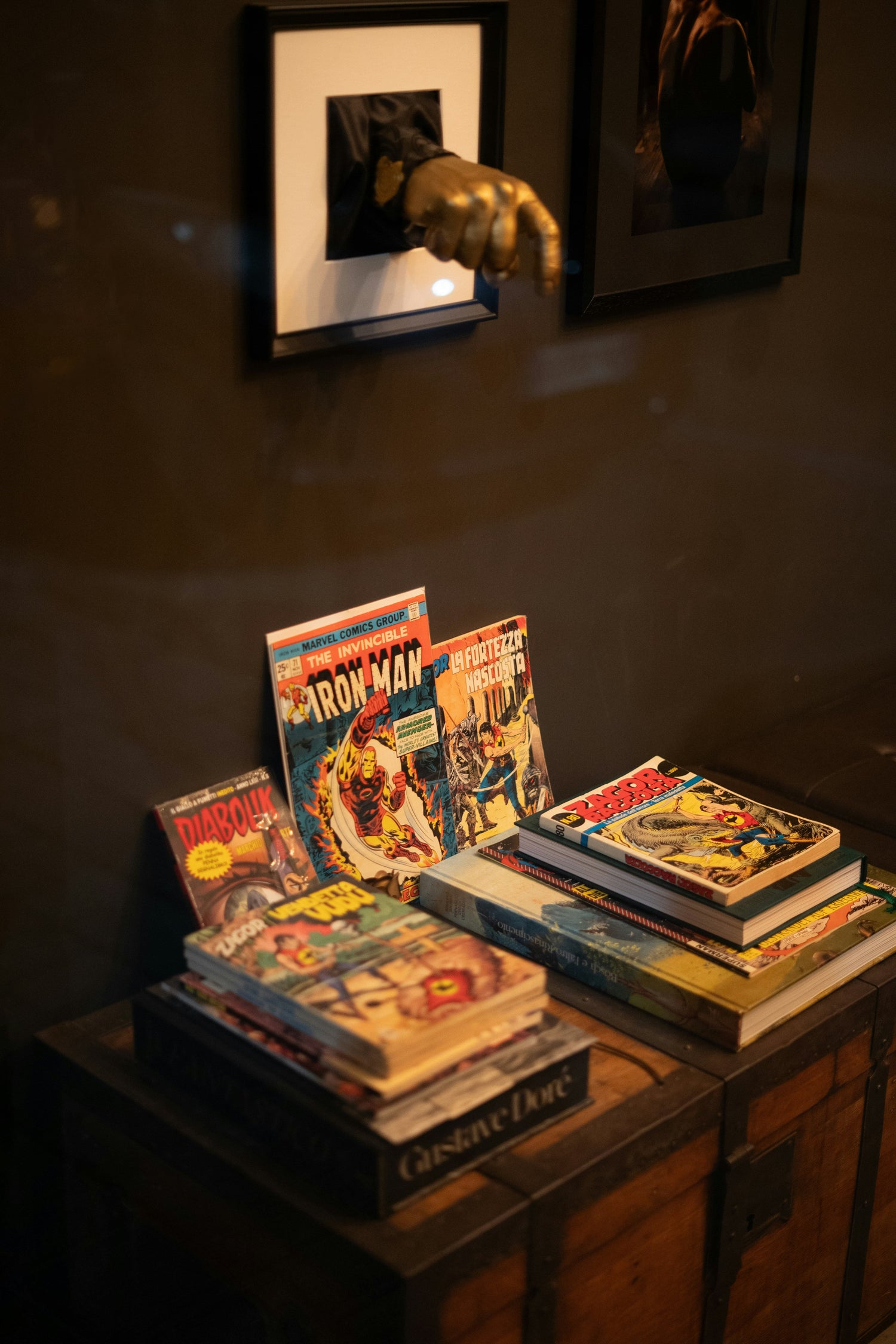 Stack of colorful comic books and hardcover novels arranged side by side