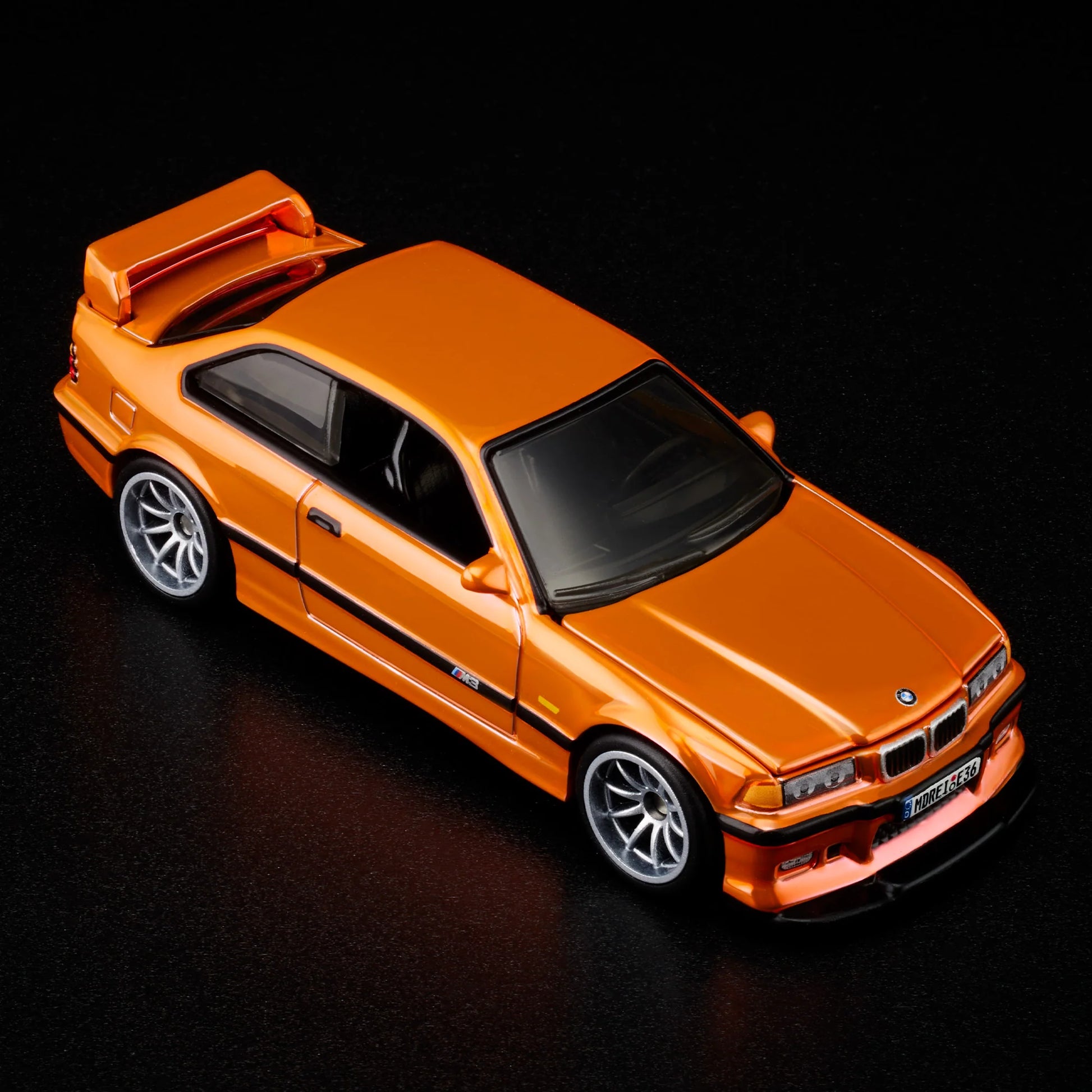 Top-down view of bright orange BMW M3 LTW 1995 Hot Wheels model