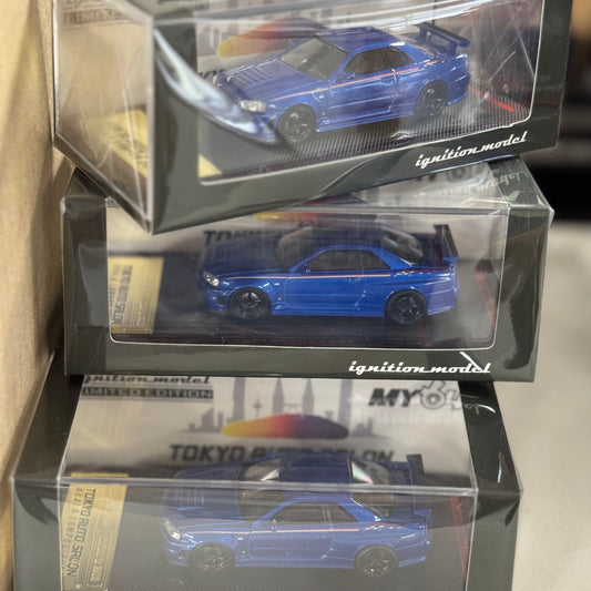 Front boxed image of IG3838 Nissan Skyline GT-R R34 V-Spec II Blue Metallic 1:64 resin model car.