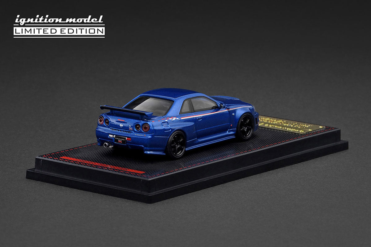 Rear angle image of IG3838 Nissan Skyline GT-R R34 with diffuser, exhaust, and aero parts.
