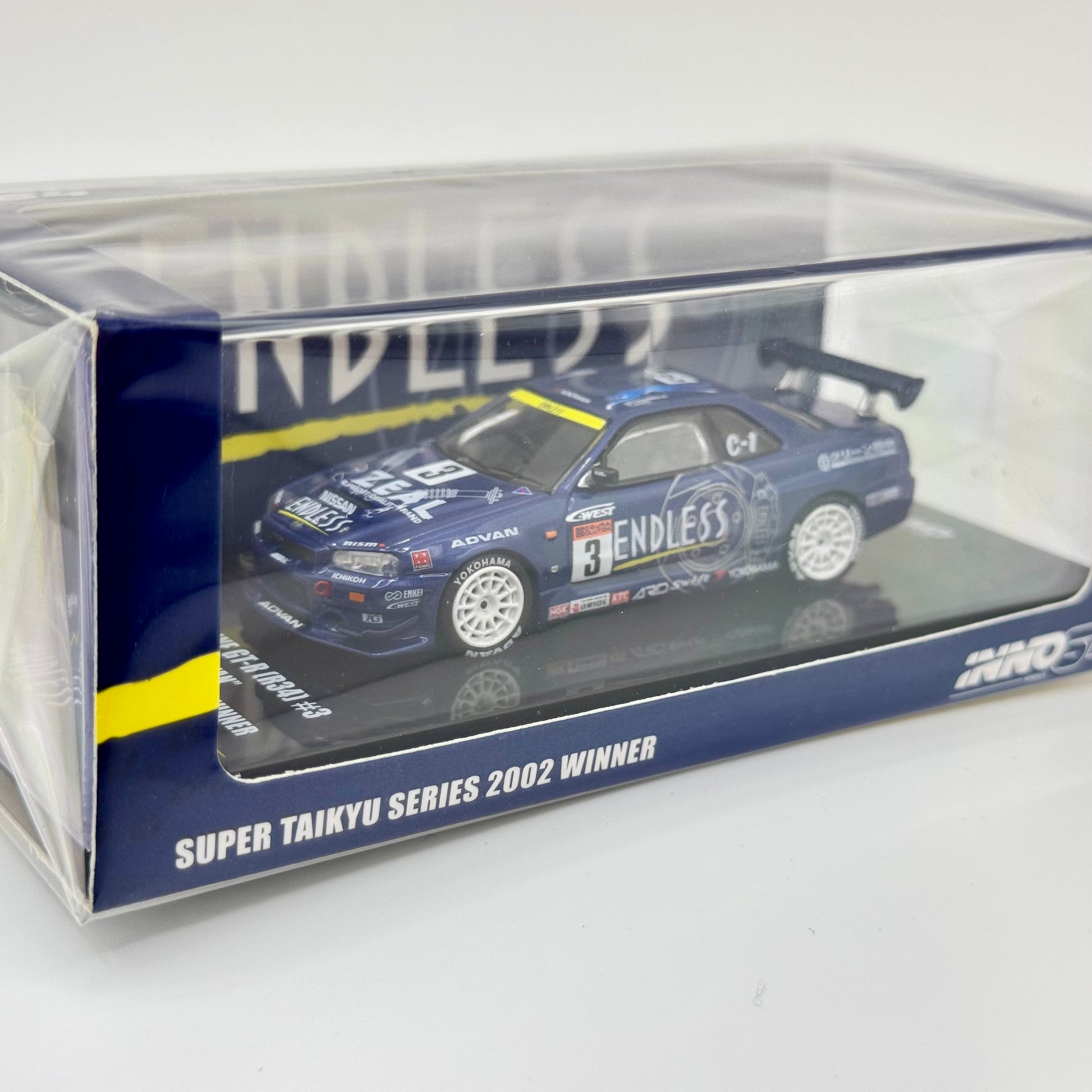Inno64 Nissan Skyline GT-R R34 #3 ENDLESS ADVAN Super Taikyu 2002 Winner 1:64 model in acrylic case front angle