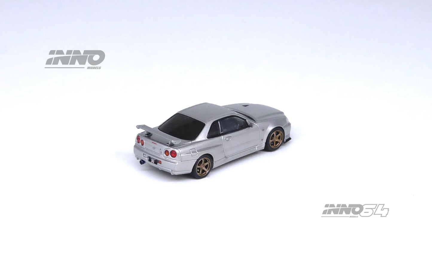 Nissan Skyline GT-R R34 V-Spec II Silver 1:64 diecast rear angle view