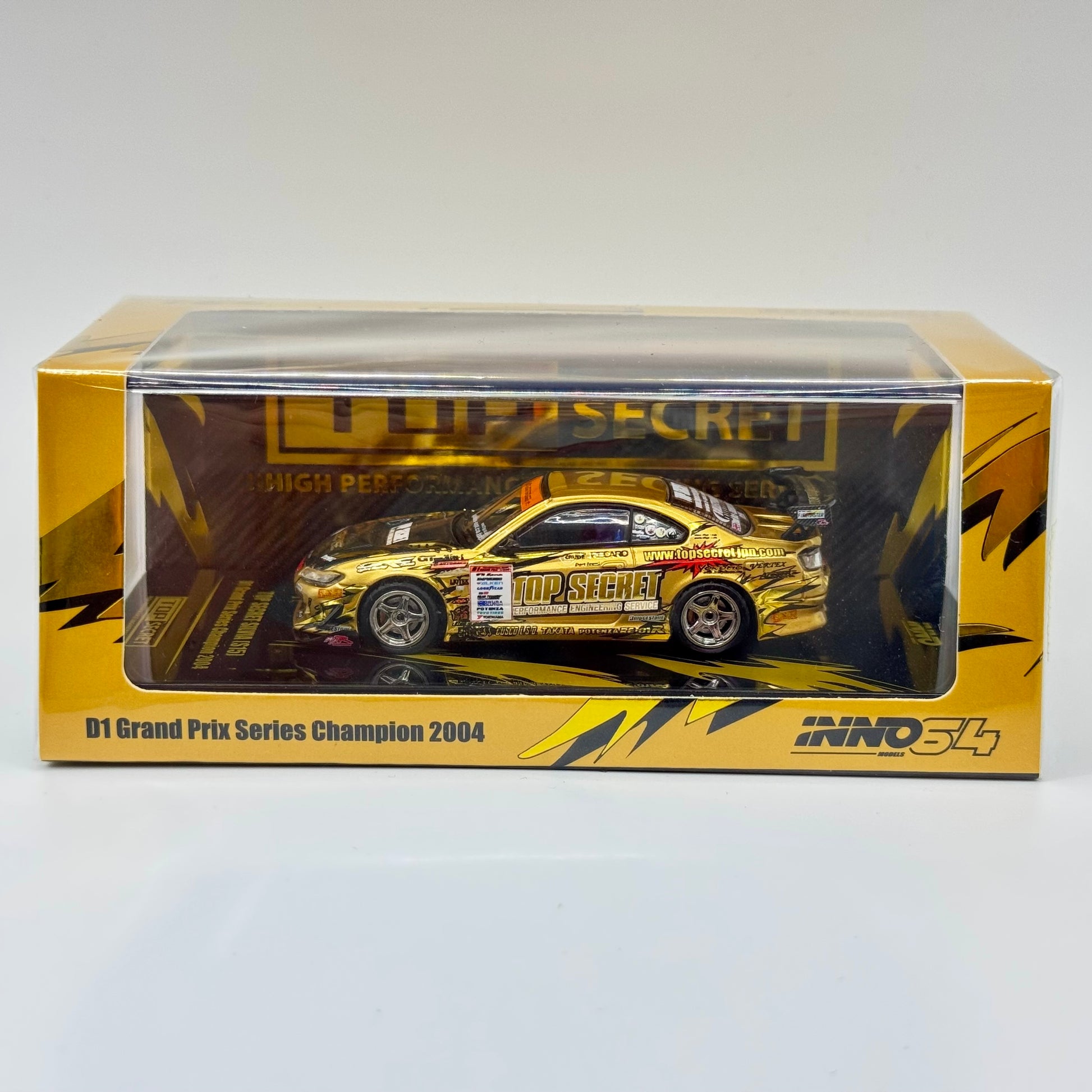 Inno64 TOP SECRET Nissan Silvia S15 Gold D1 Grand Prix 2004 1:64 diecast model boxed front view