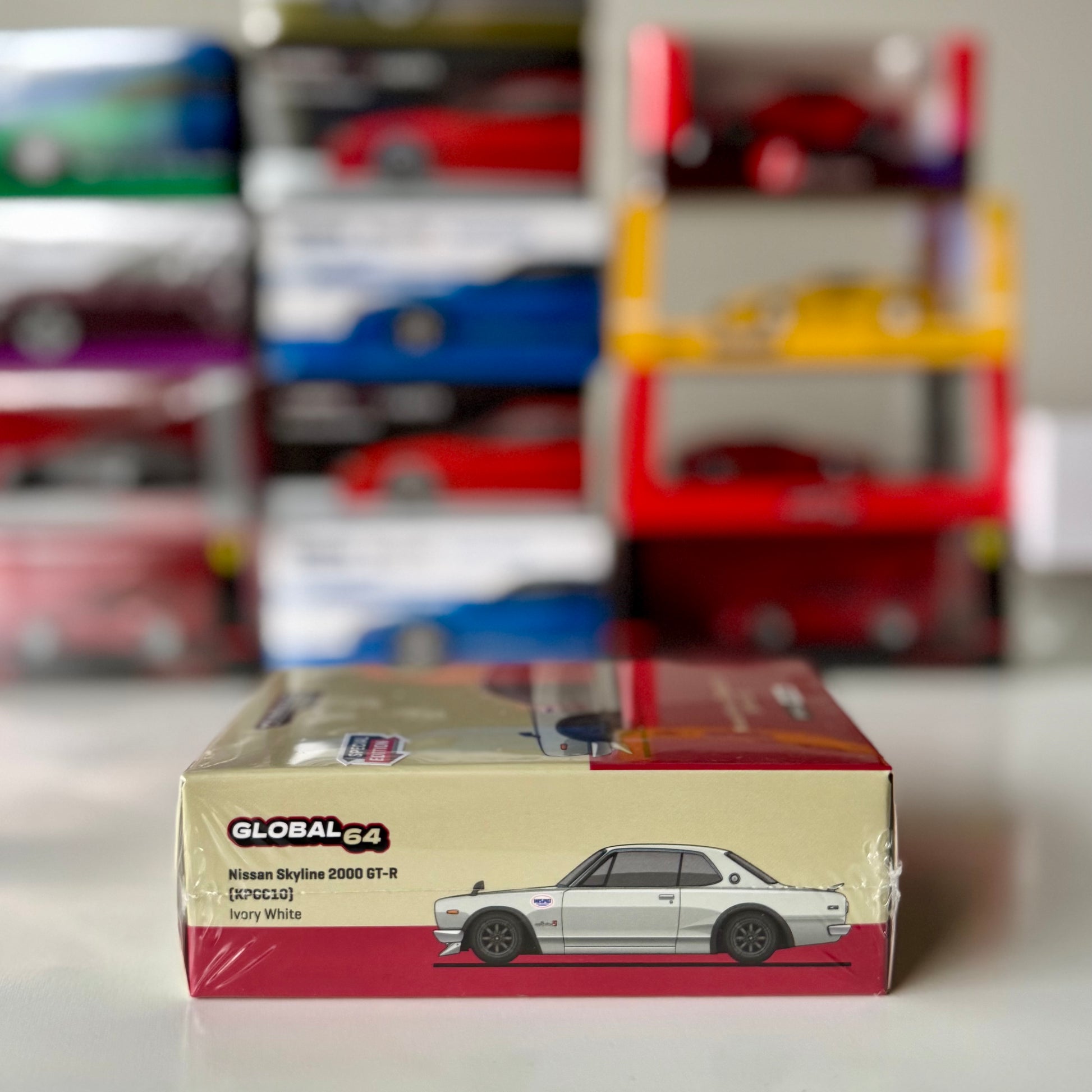 Angled boxed view of 1:64 scale Nissan Skyline GT-R Ivory White model