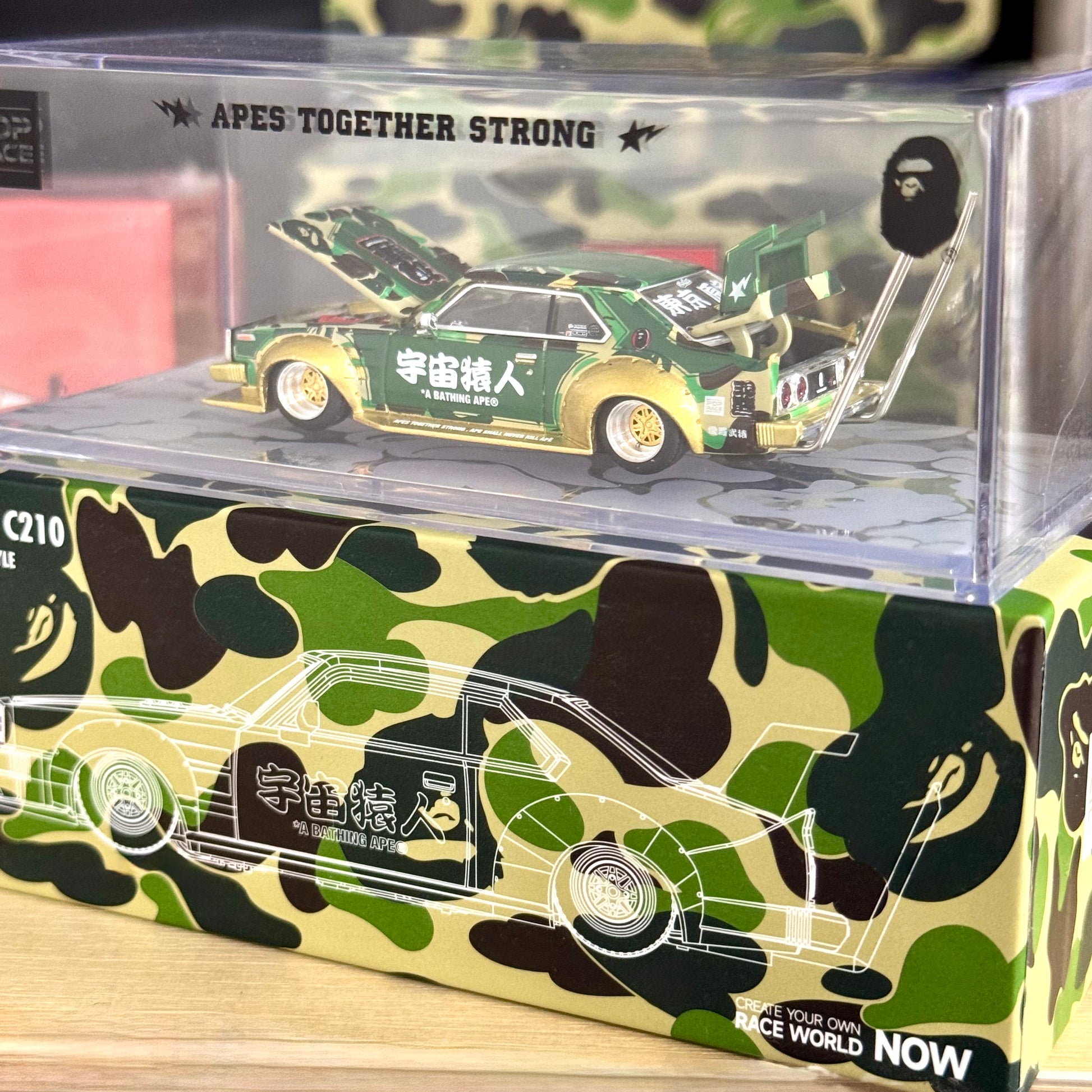 Left side angle of diecast Kaido Racer Skyline BAPE inside acrylic case