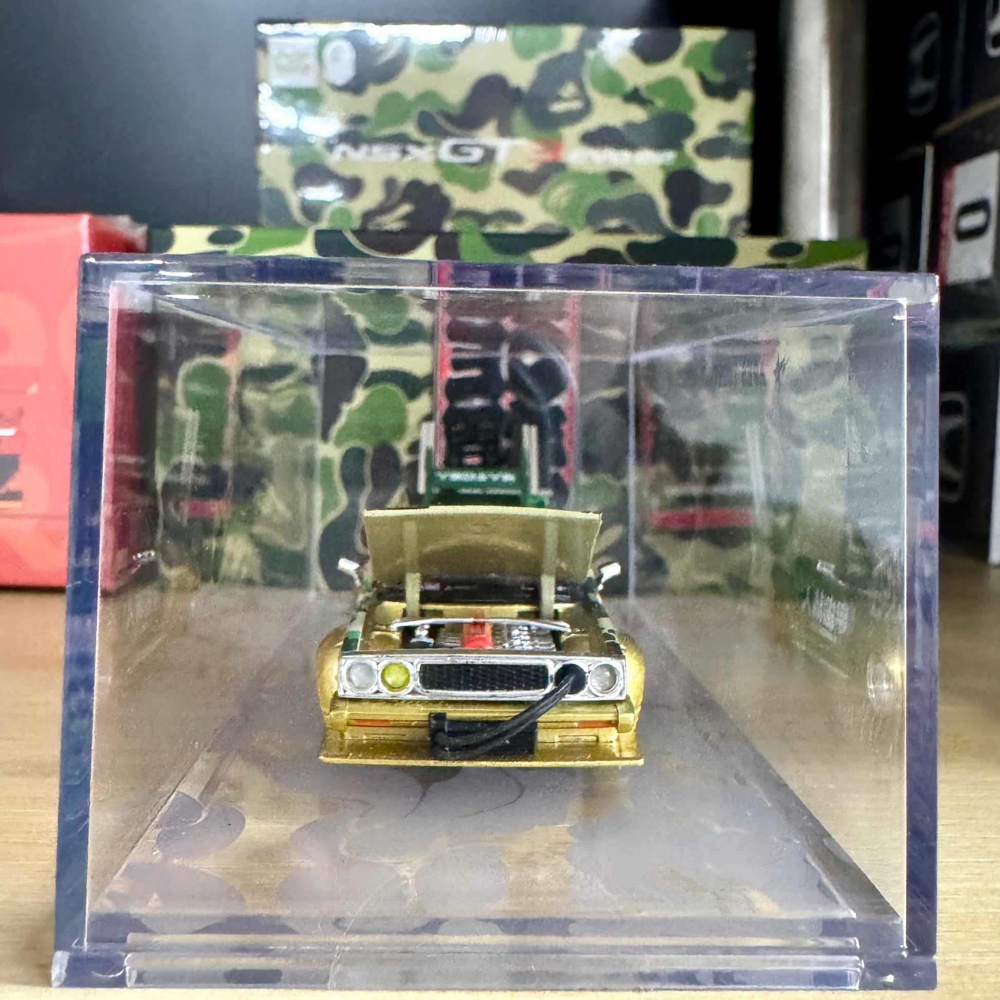 Front view of Nissan Skyline C210 Kaido Racer BAPE 30th Anniversary in acrylic case