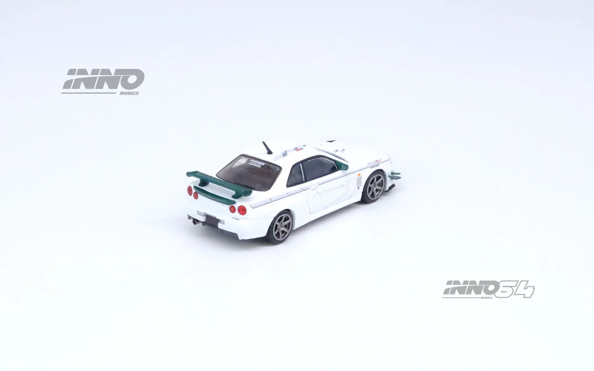 Rear side profile of INNO64 R34 GT-R V-Spec N1 Mine’s White out of box