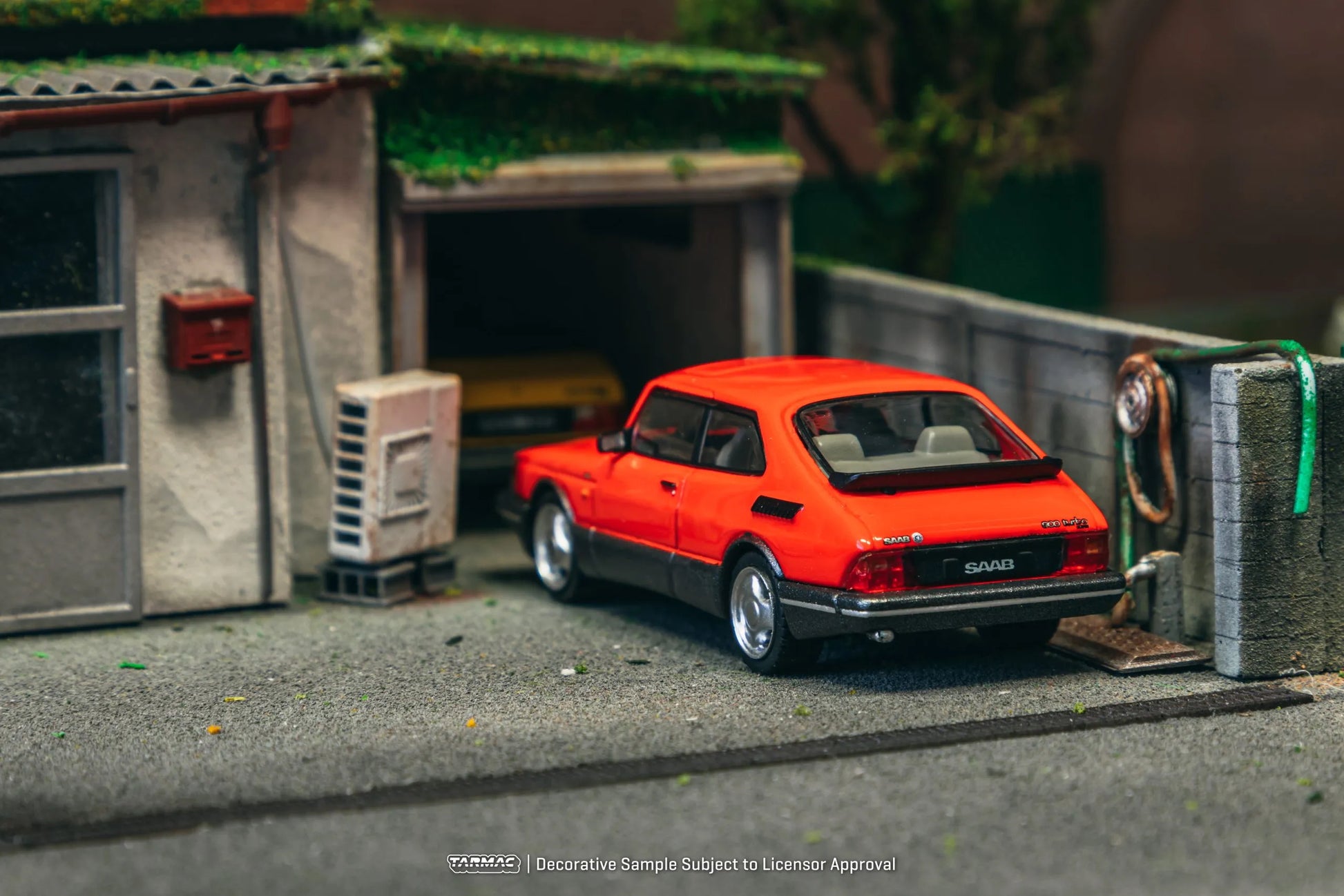 Saab 900 Turbo Red diecast model displayed in diorama scene – back view