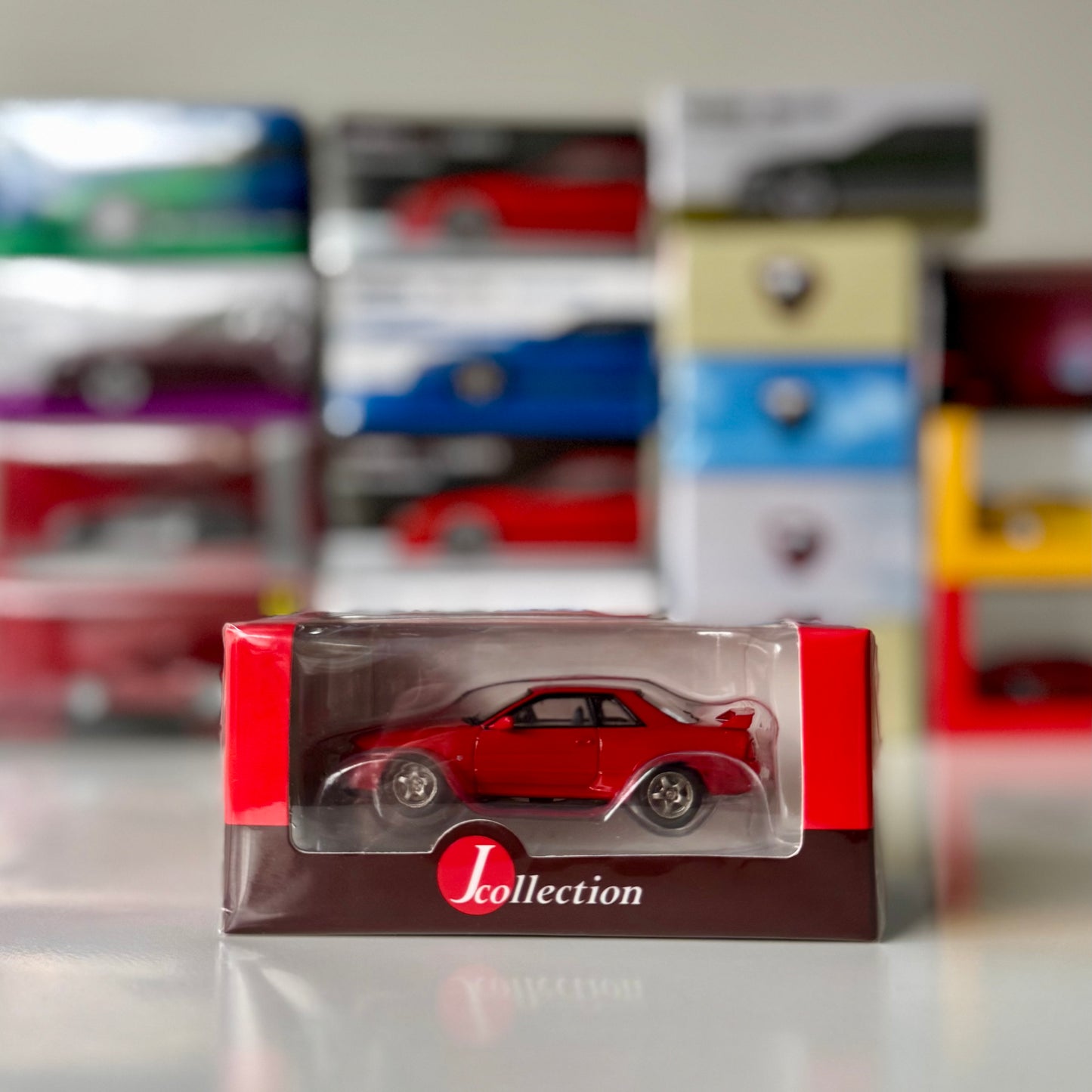 Front view of boxed Nissan Skyline GT-R BNR32 Red 1:64 by Tarmac Works