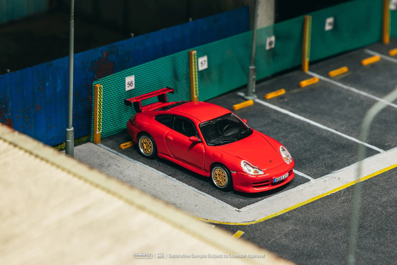 Porsche 911 GT3 996 Red 1:64 diecast displayed in garage diorama setting