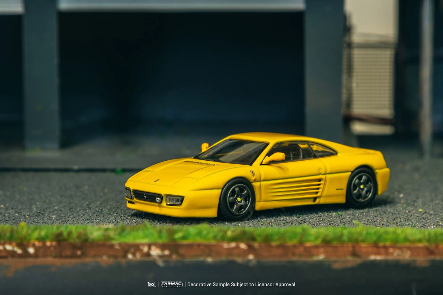 Ferrari 348 Challenge Yellow 1:64 diecast displayed in garage diorama